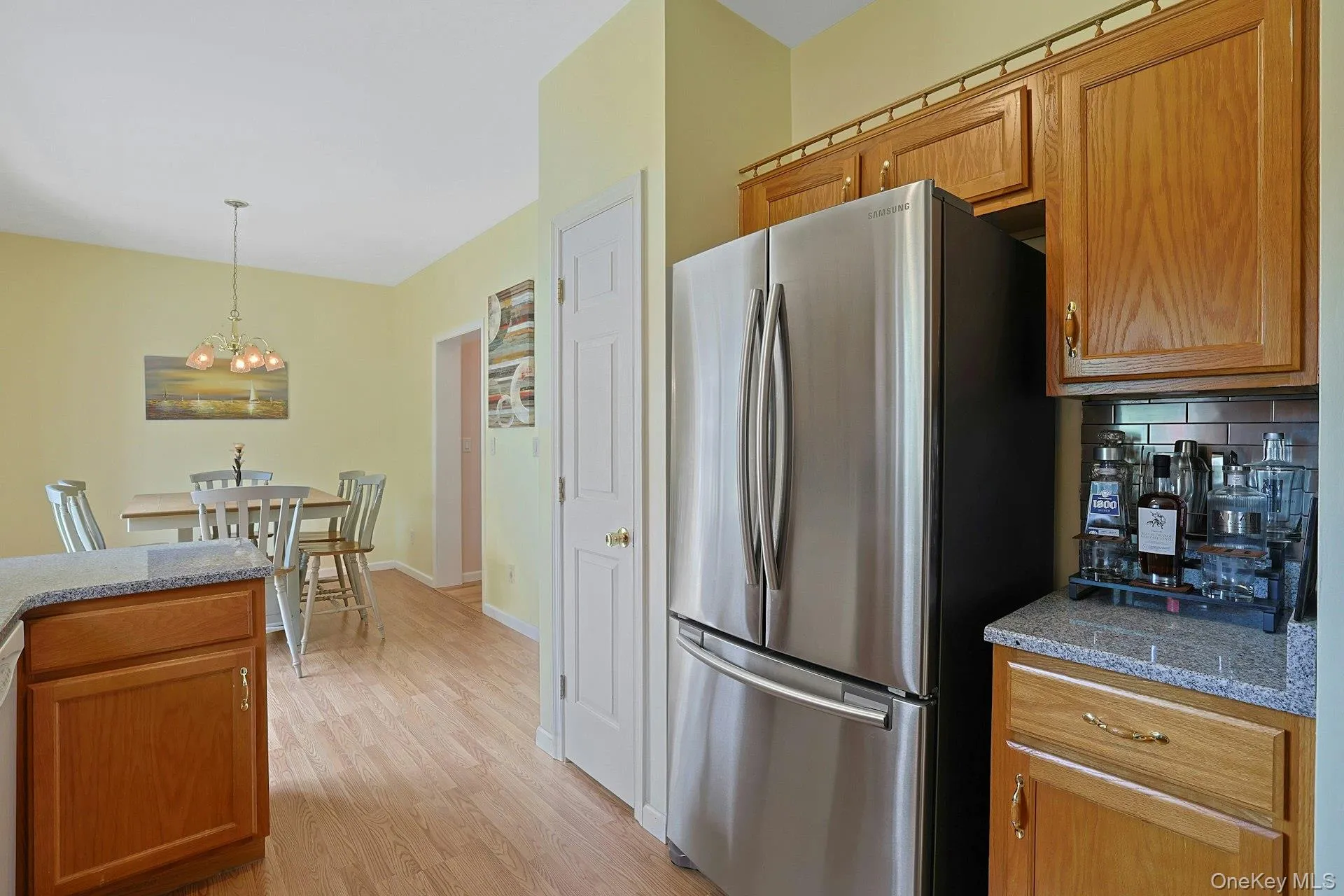 A stainless steel refrigerator complements the kitchen's clean, updated feel. A stainless steel refrigerator complements the kitchen's clean, updated feel.