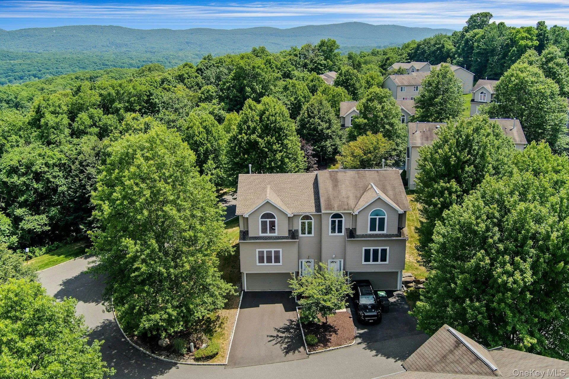 Aerial view of the front of the home, including the two-car garage and private driveway. Aerial view of the front of the home, including the two-car garage and private driveway.