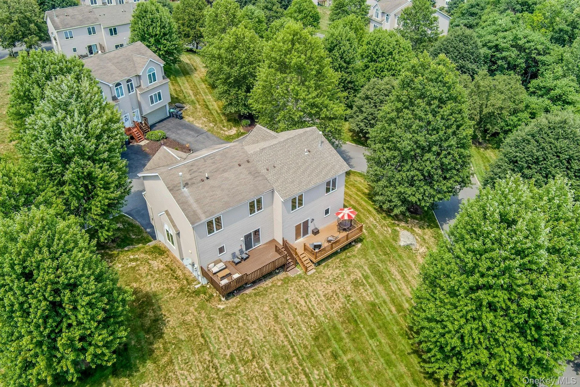 Aerial view showcasing the rear of the unit, large deck, and surrounding open space. Aerial view showcasing the rear of the unit, large deck, and surrounding open space.