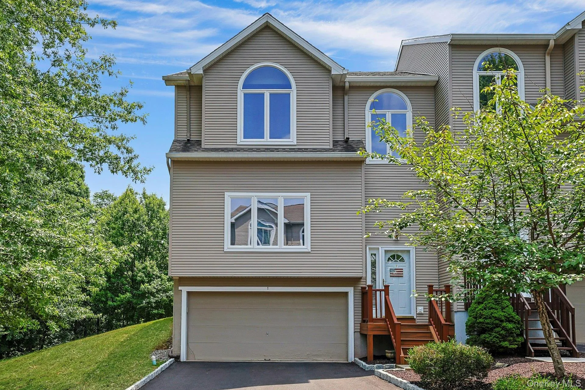 Welcoming front exterior with a two-car garage and private driveway. Welcoming front exterior with a two-car garage and private driveway.