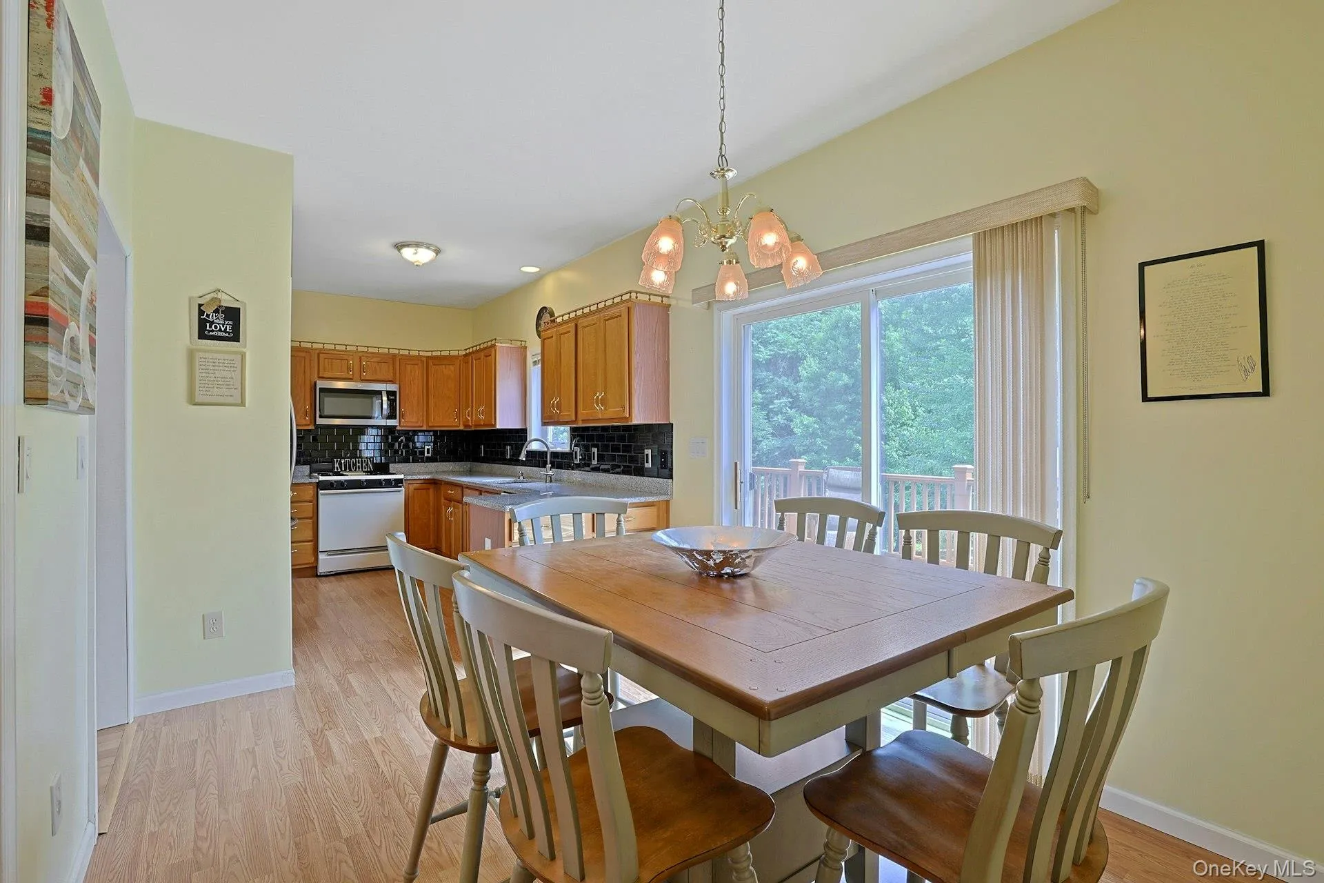 The eat-in kitchen with sliding glass doors open to the deck. The eat-in kitchen with sliding glass doors open to the deck.