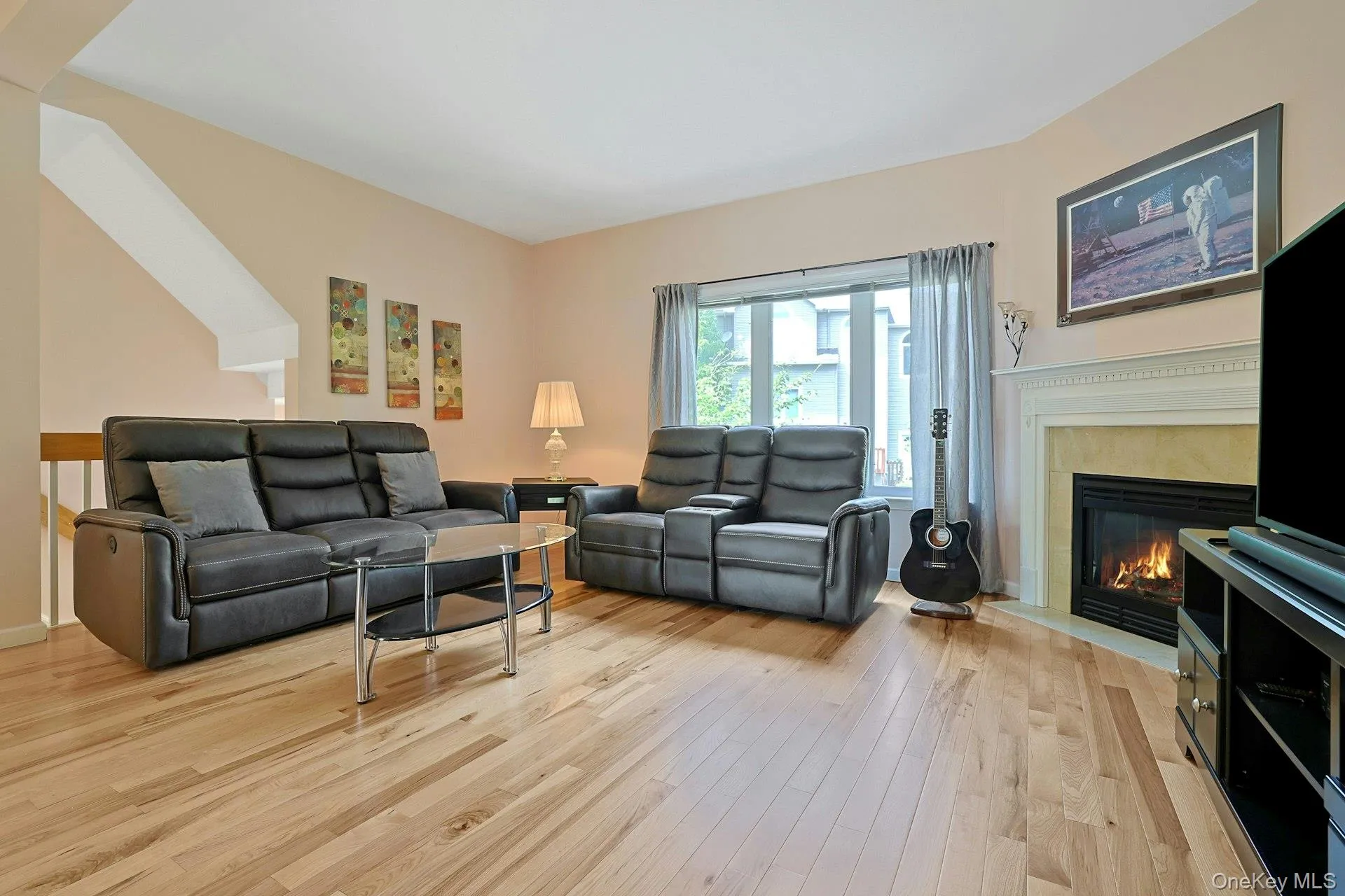 Bright living room with a beautiful marble surround gas fireplace and warm, welcoming feel. Bright living room with a beautiful marble surround gas fireplace and warm, welcoming feel.