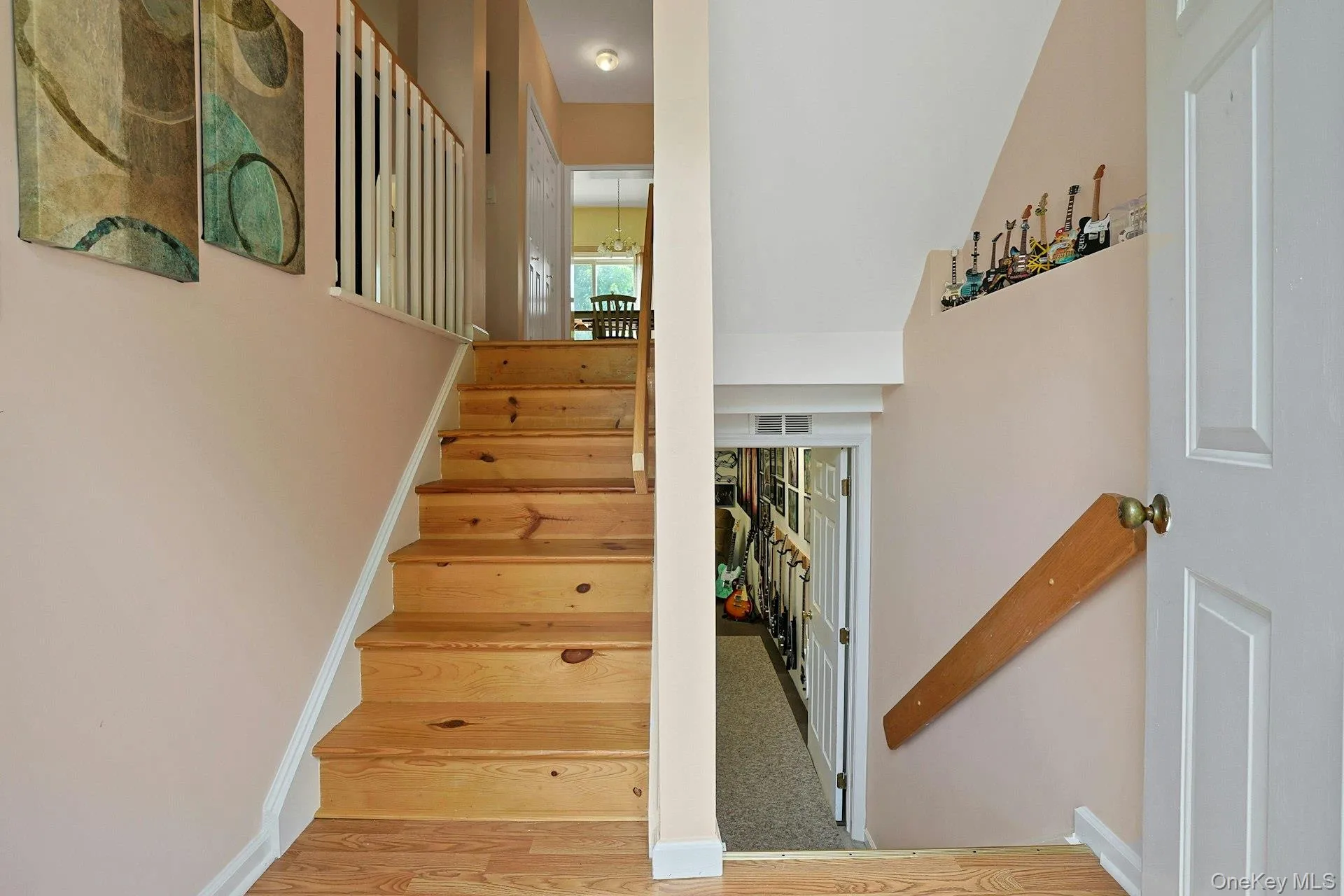 The entry staircase connects the main living area upstairs with additional lower-level space below. The entry staircase connects the main living area upstairs with additional lower-level space below.