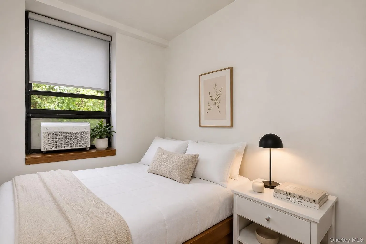 White walls, black-framed window, and a wooden window sill. White walls, black-framed window, and a wooden window sill.