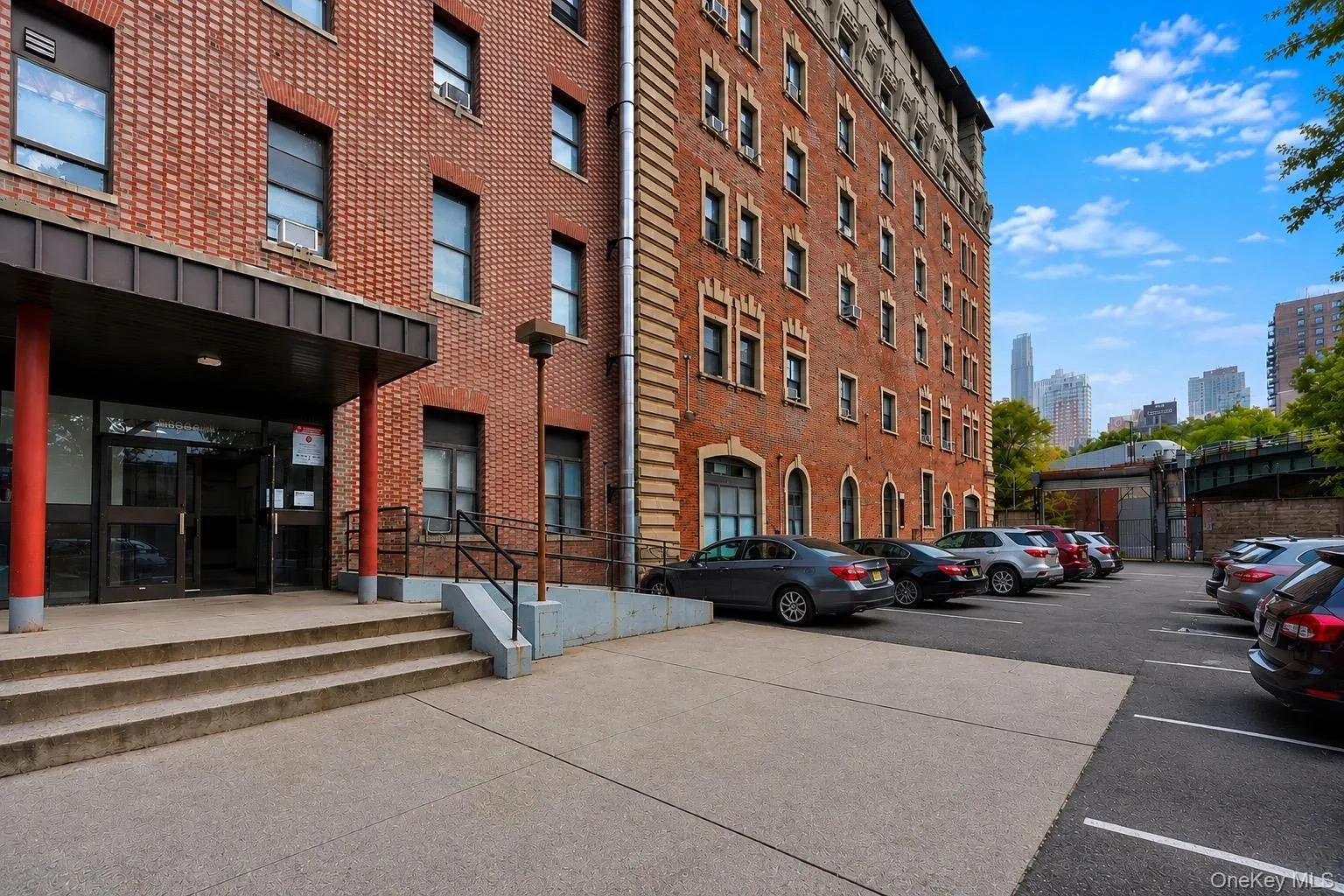 Brick facade with large multi-pane windows and parking lot. Brick facade with large multi-pane windows and parking lot.