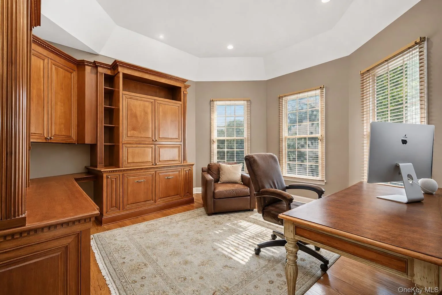 Built-in wood cabinetry and shelving define this office space Built-in wood cabinetry and shelving define this office space