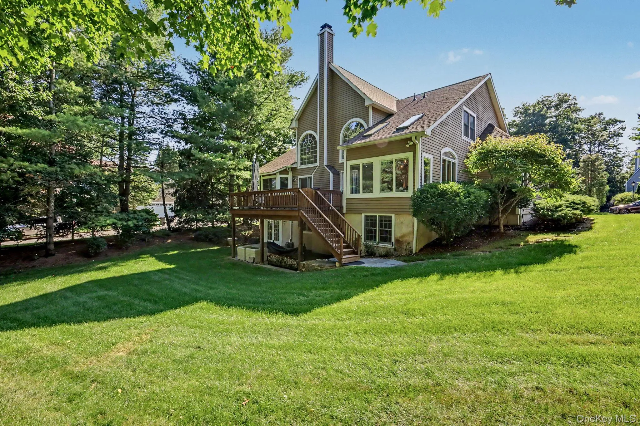 Spacious rear yard with a multi-level deck and staircase Spacious rear yard with a multi-level deck and staircase