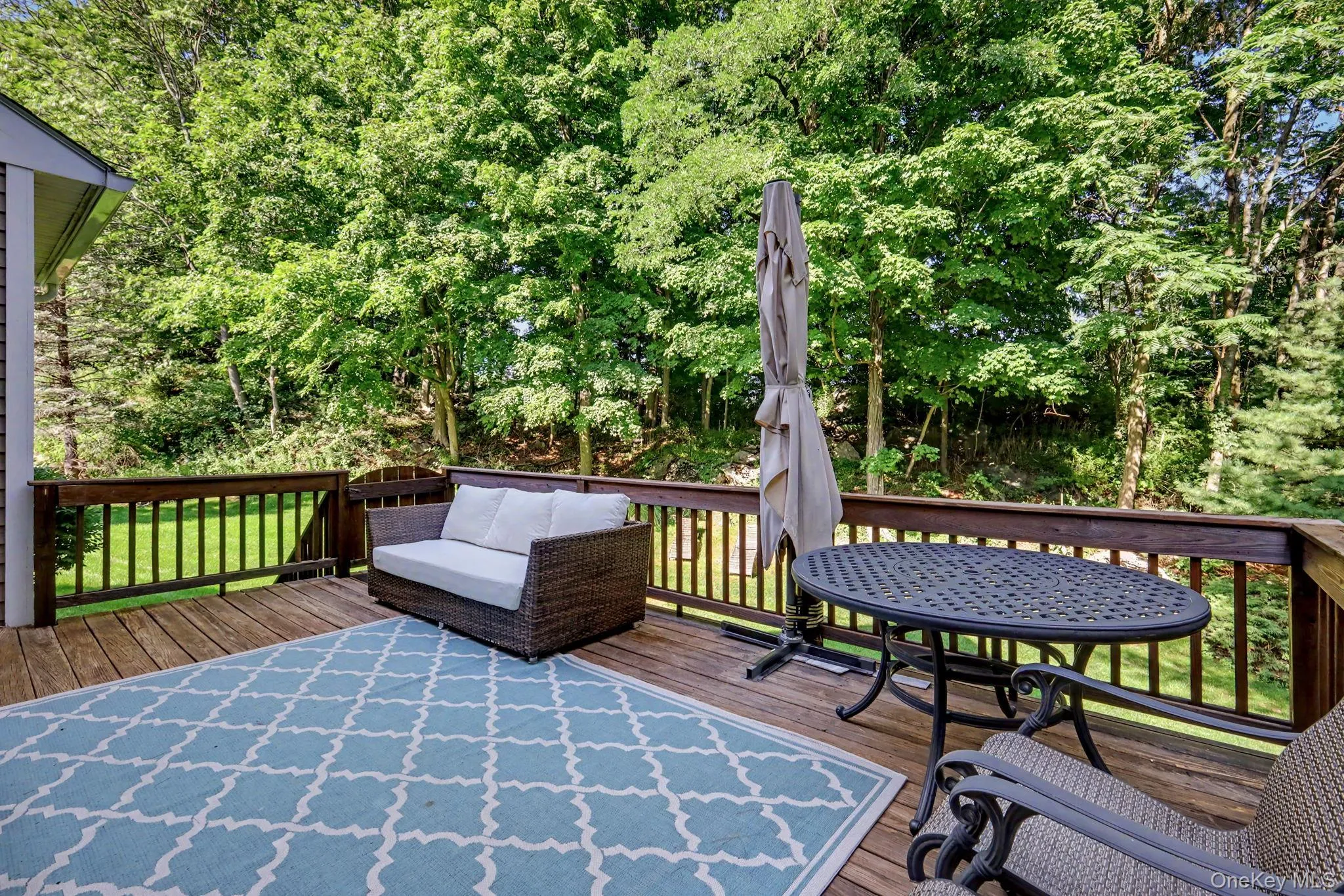 Spacious wood-finish deck surrounded by mature trees for privacy. Spacious wood-finish deck surrounded by mature trees for privacy.
