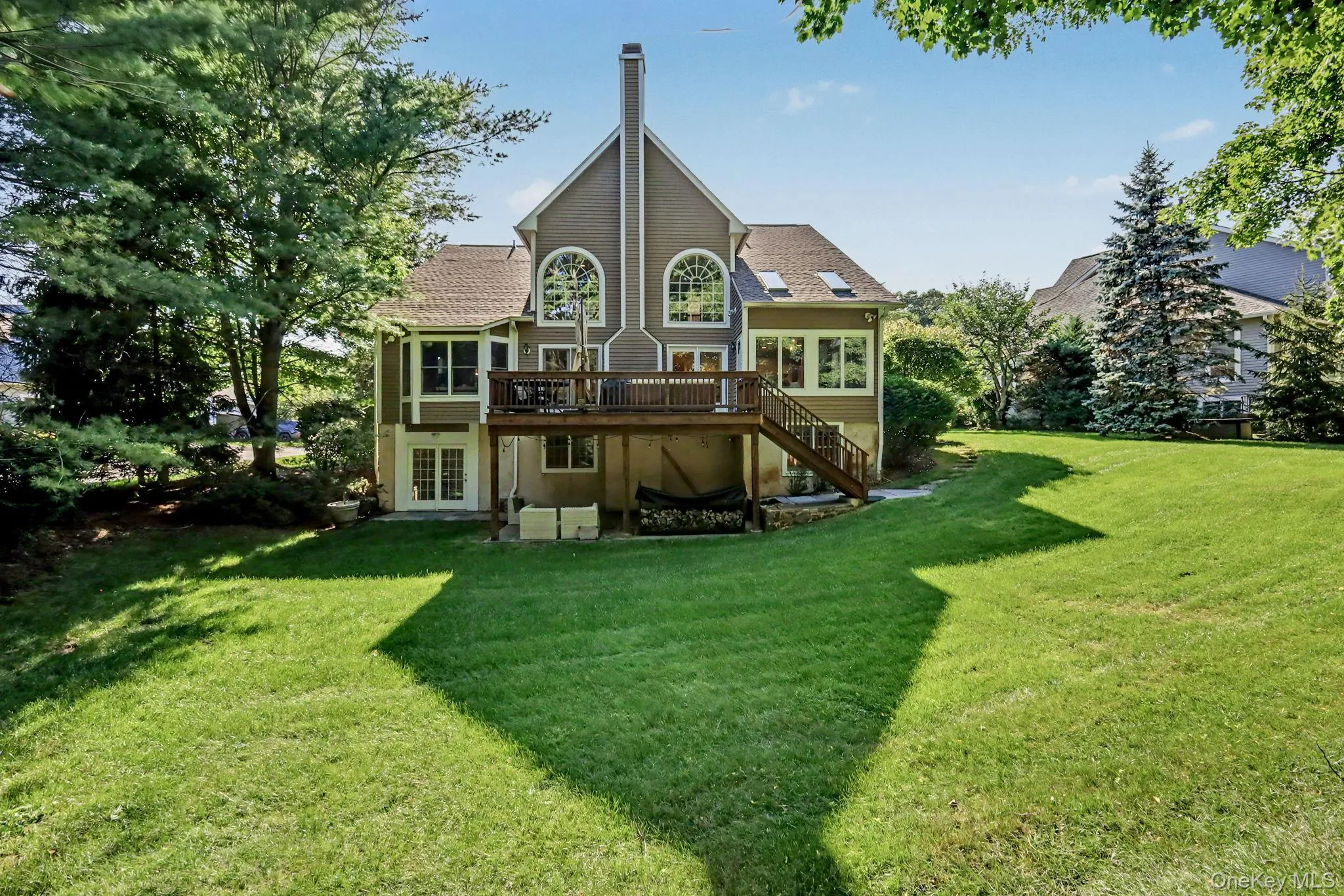 Beautiful back of the house view. Expansive green lawn Beautiful back of the house view. Expansive green lawn