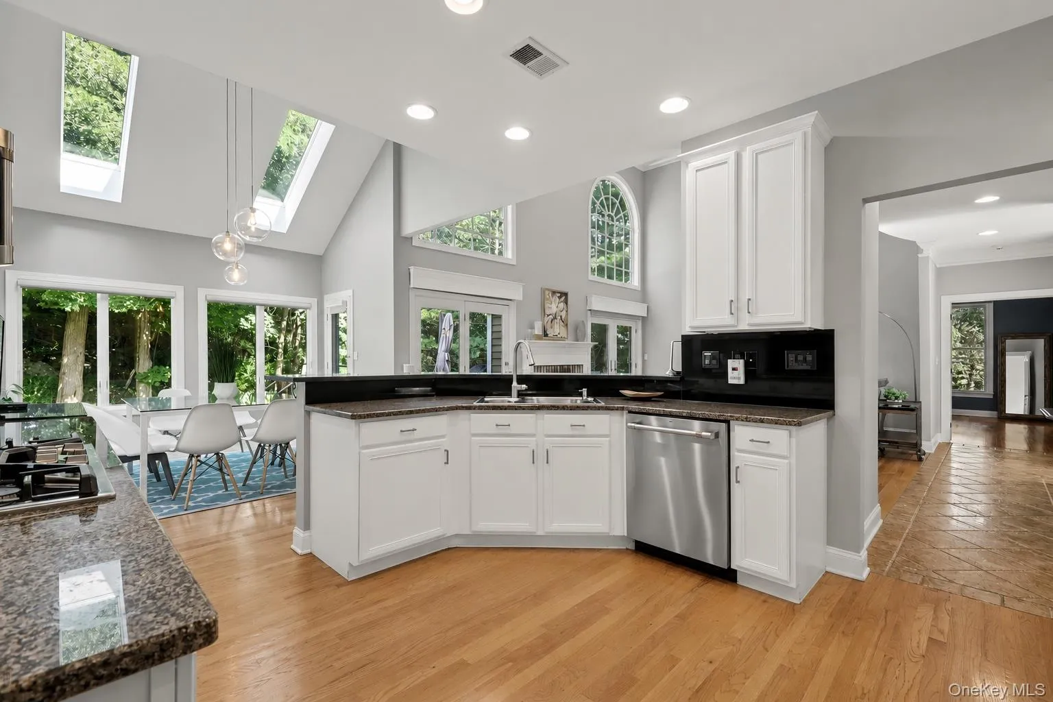 Kitchen featuring white cabinetry and granite countertops Kitchen featuring white cabinetry and granite countertops