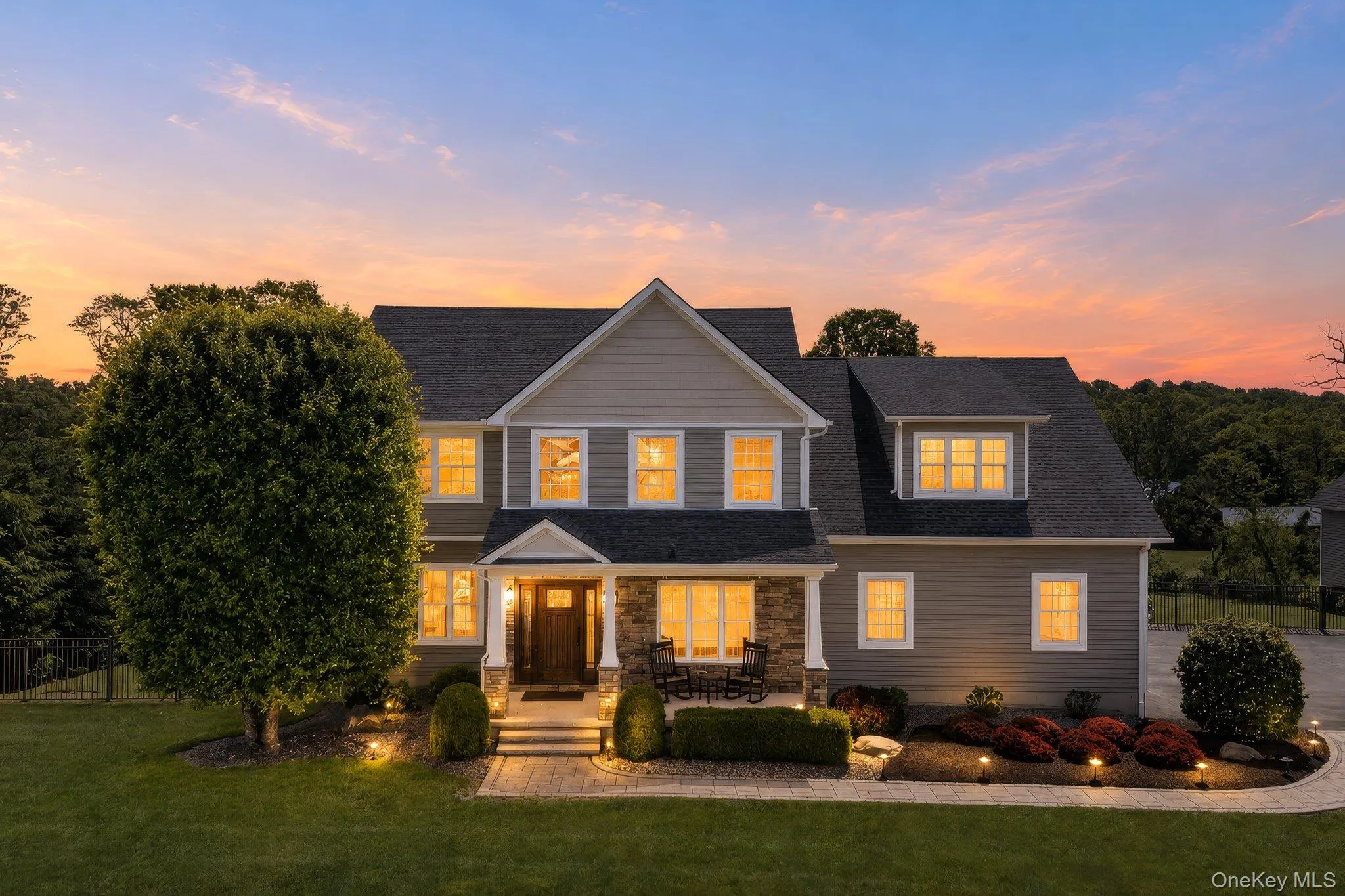 Classic Colonial-style residence featuring a stone and siding exterior Classic Colonial-style residence featuring a stone and siding exterior
