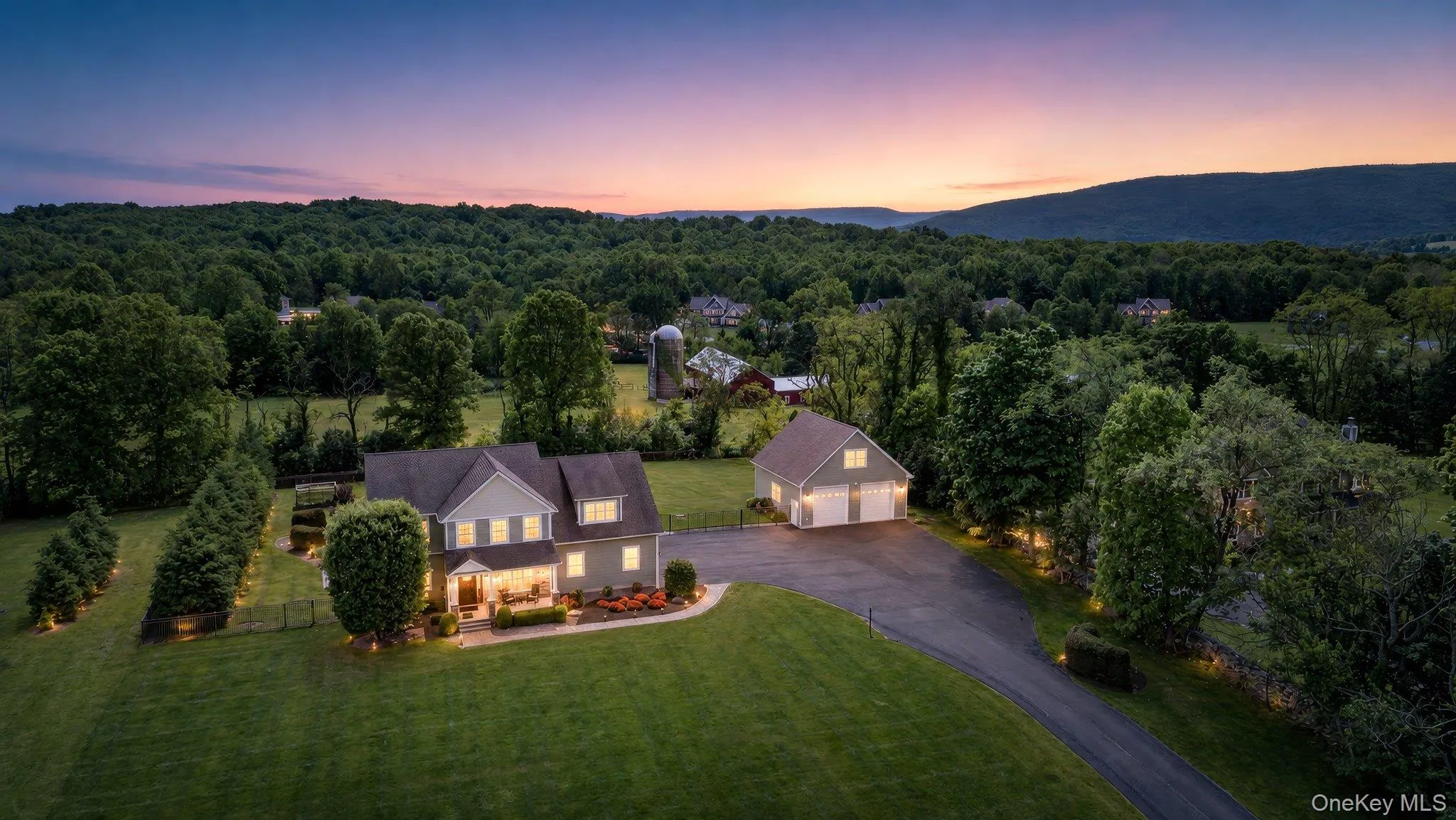 Spacious property featuring a two-story residence with a detached three-car garage, extensive paved driveway, and mature landscaping Spacious property featuring a two-story residence with a detached three-car garage, extensive paved driveway, and mature landscaping