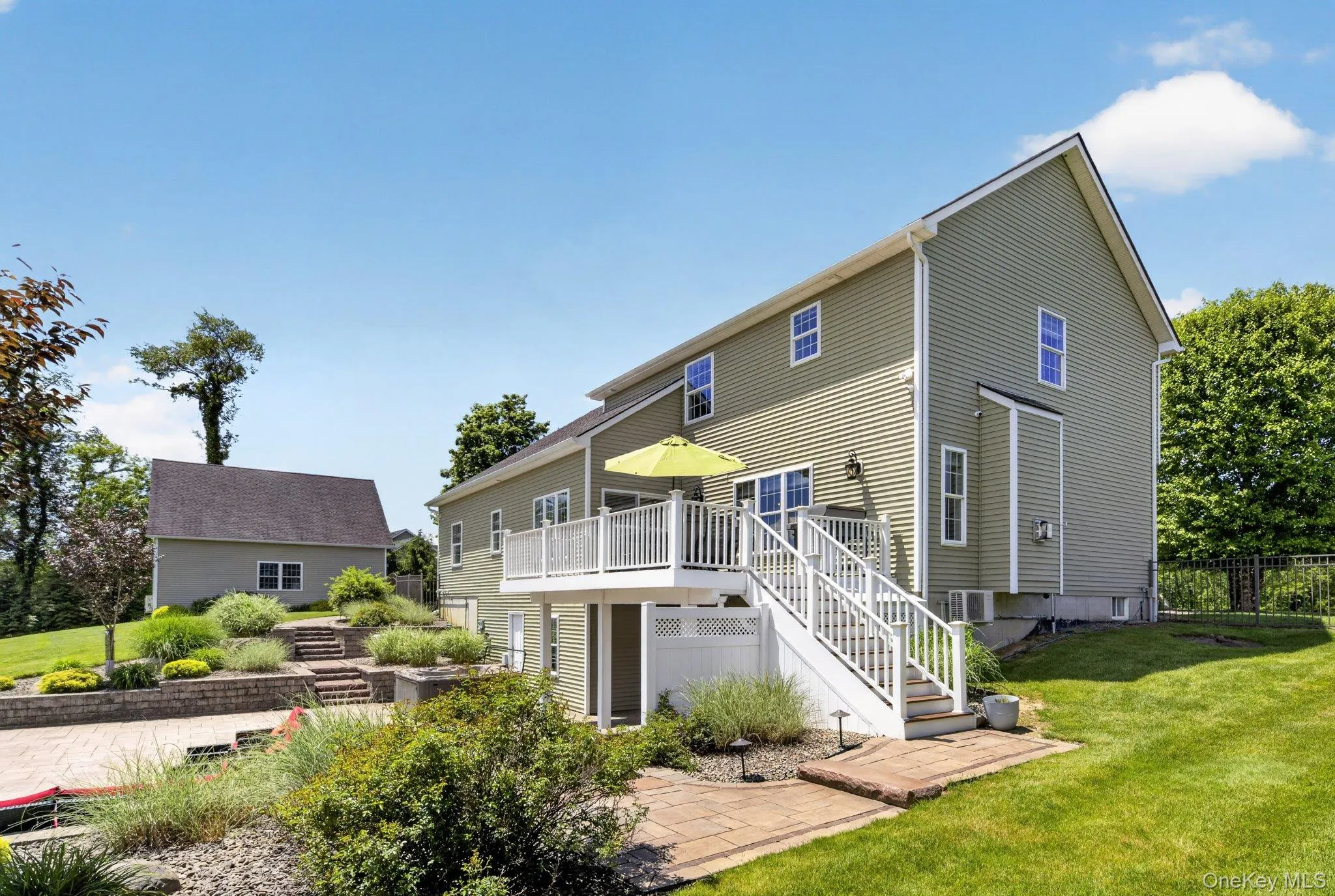 Two-story residence featuring light green siding and white trim windows Two-story residence featuring light green siding and white trim windows