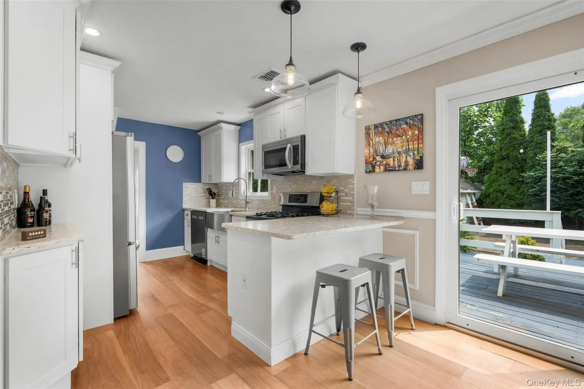 Kitchen featuring white shaker cabinetry and stainless steel appliances. Kitchen featuring white shaker cabinetry and stainless steel appliances.