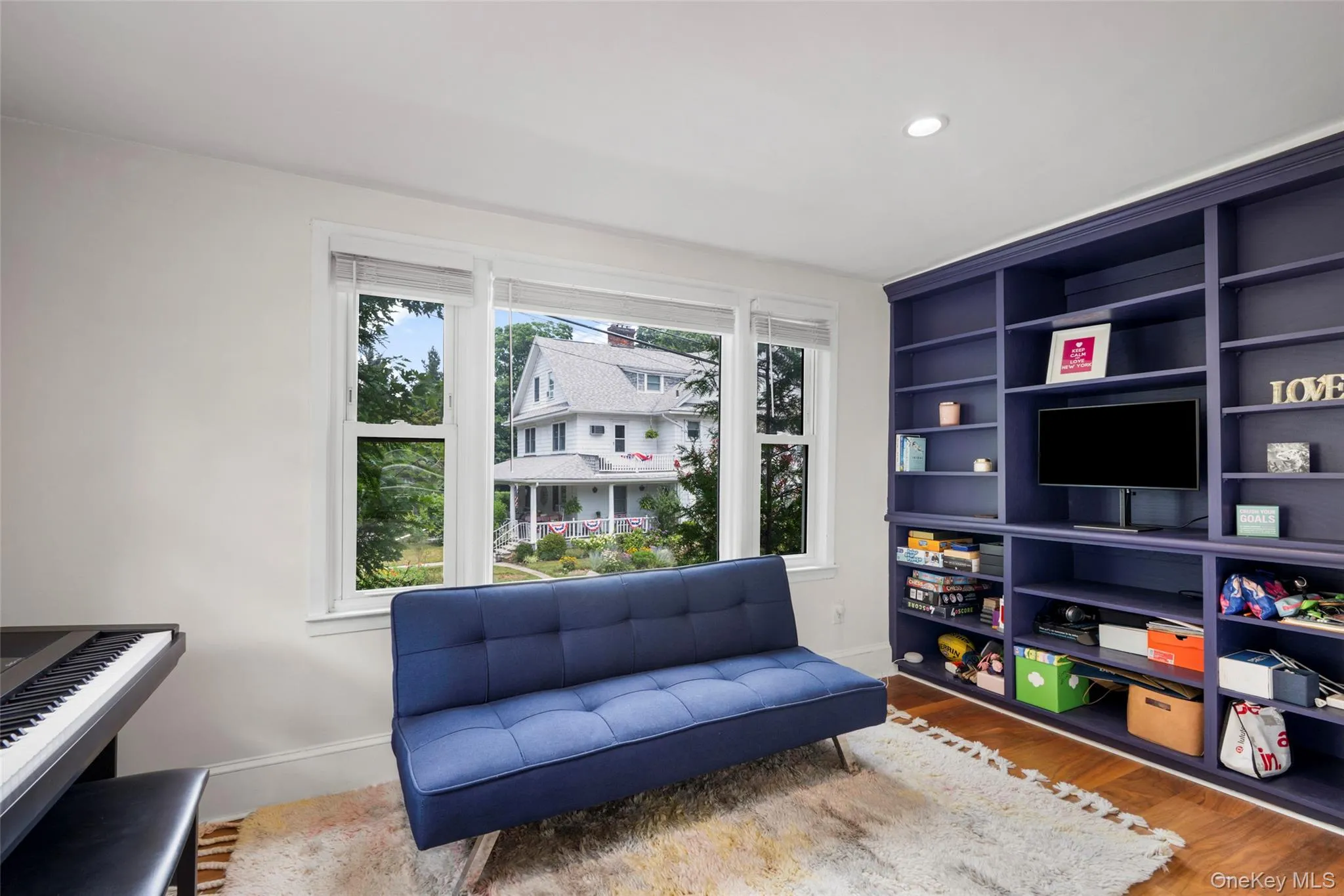 Full wall of built-in shelving with an integrated media console. Full wall of built-in shelving with an integrated media console.