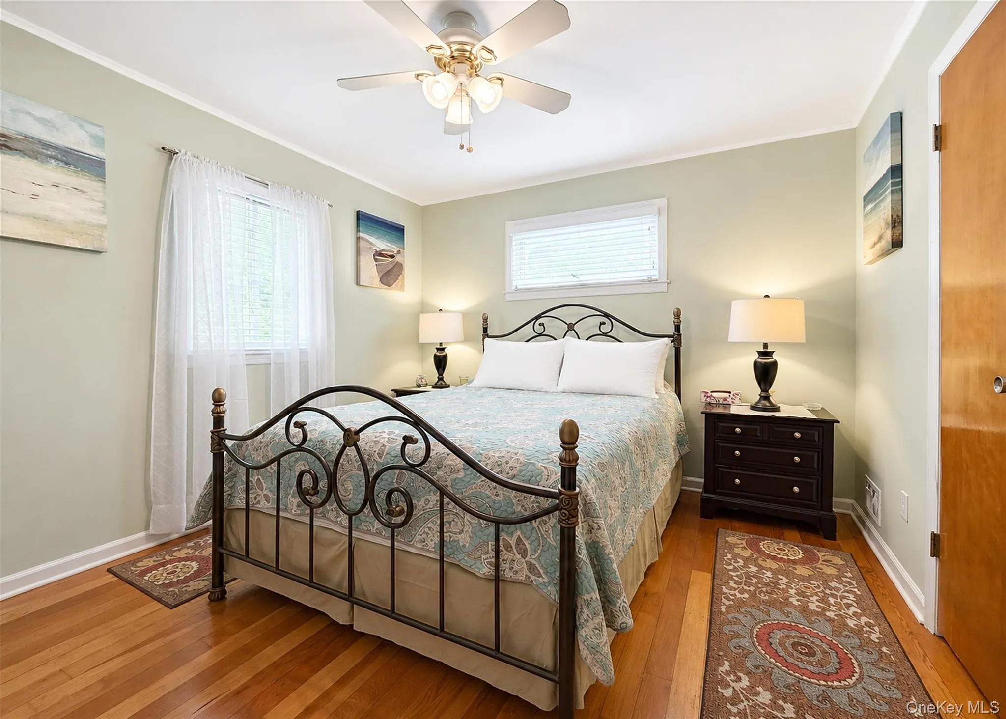 Primary Bedroom With Hardwood Flooring, Ceiling Fan, & Ample Closet Space. Primary Bedroom With Hardwood Flooring, Ceiling Fan, & Ample Closet Space.