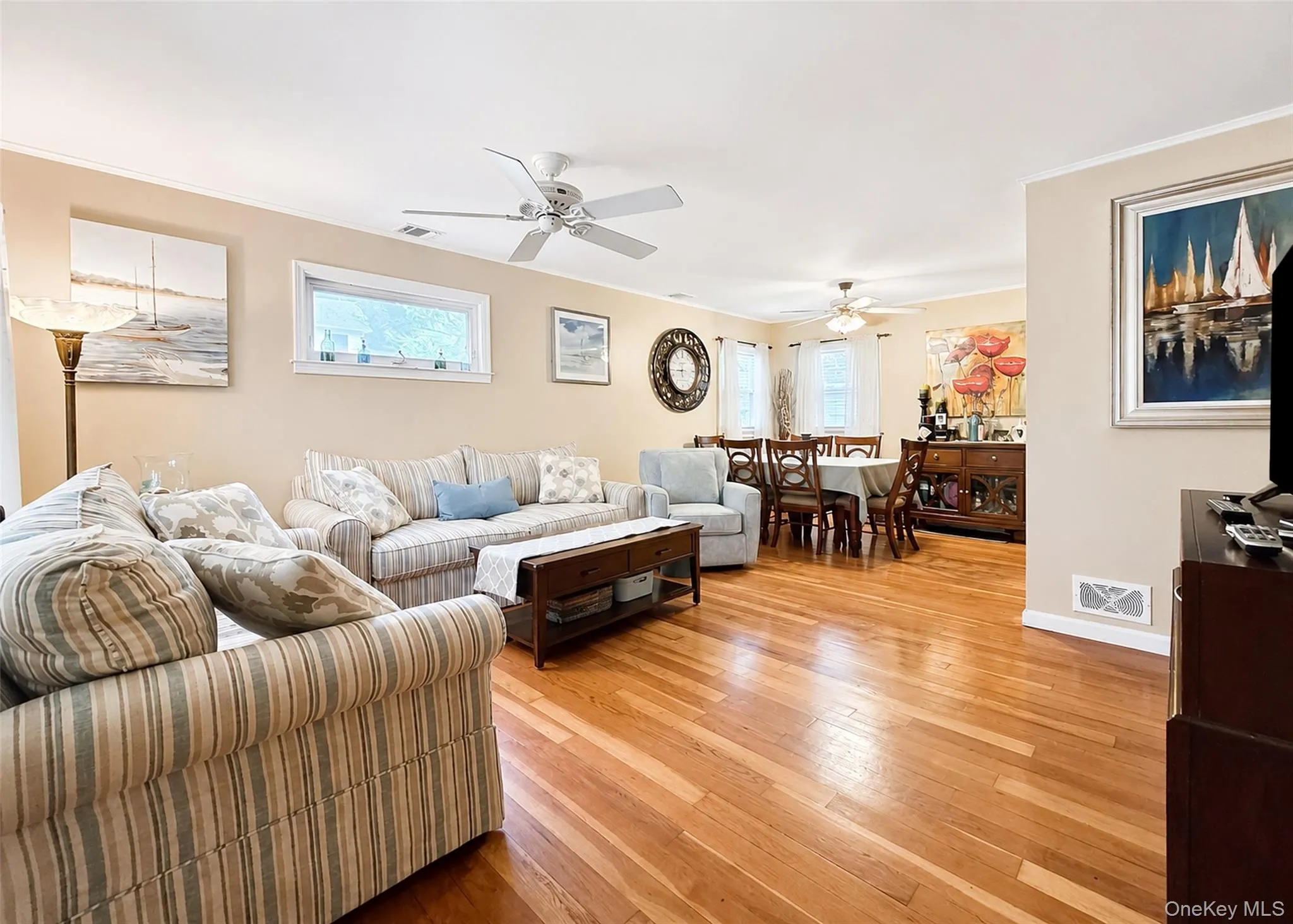Sunlit Living Room With Hardwood Flooring & Ceiling Fan. Sunlit Living Room With Hardwood Flooring & Ceiling Fan.