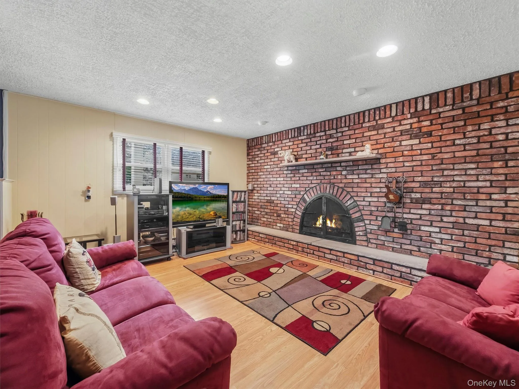 The family room downstairs is awesome for entertaining and relaxing. Please note that the fireplace is decorative and non-connected. Picture was edited to show how it could look. The family room downstairs is awesome for entertaining and relaxing. Please note that the fireplace is decorative and non-connected. Picture was edited to show how it could look.