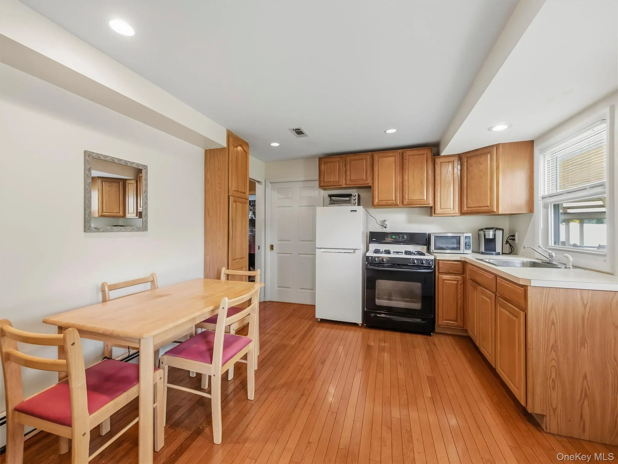 Kitchen featuring Oven/Stove, Refrigerator, recessed lighting, ample cabinetry, and plenty of countertop space. Kitchen featuring Oven/Stove, Refrigerator, recessed lighting, ample cabinetry, and plenty of countertop space.