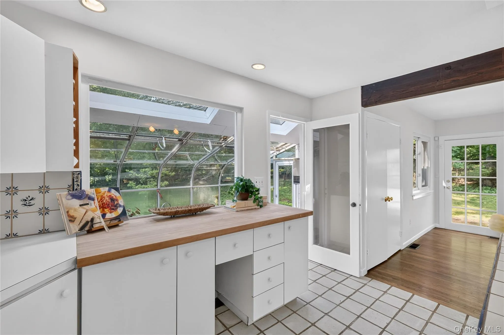 Large kitchen with island, door to greenhouse Large kitchen with island, door to greenhouse