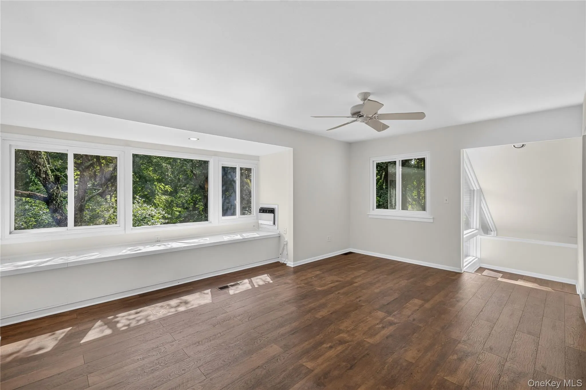 Bright primary suite with closets, skylight, window seat Bright primary suite with closets, skylight, window seat