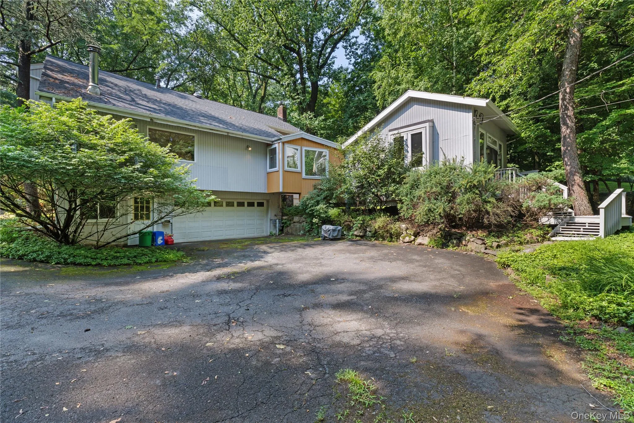 Driveway to 2-car garage and studio on right with separate entry Driveway to 2-car garage and studio on right with separate entry