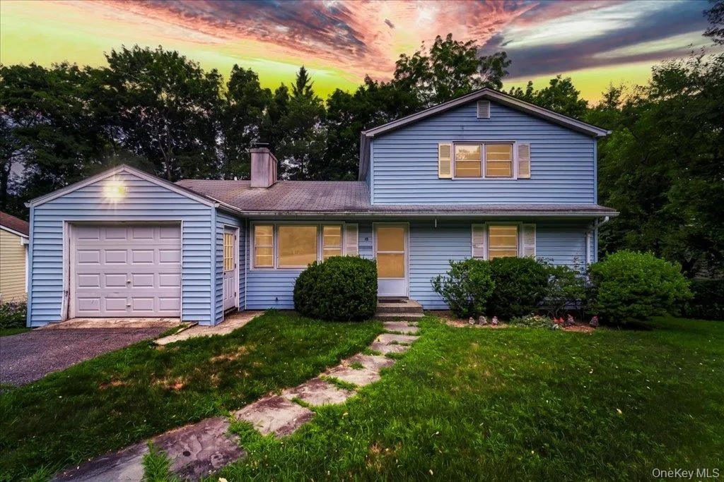 Light blue siding exterior featuring a white garage door, front entry with a screen door, and multiple windows with shutters Light blue siding exterior featuring a white garage door, front entry with a screen door, and multiple windows with shutters