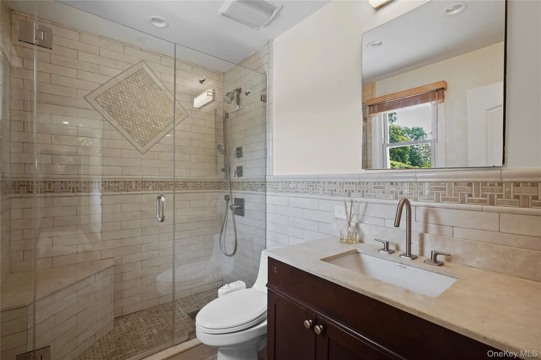 Upstairs hall bath boasts a large walk-in shower and tumbled marble accents Upstairs hall bath boasts a large walk-in shower and tumbled marble accents
