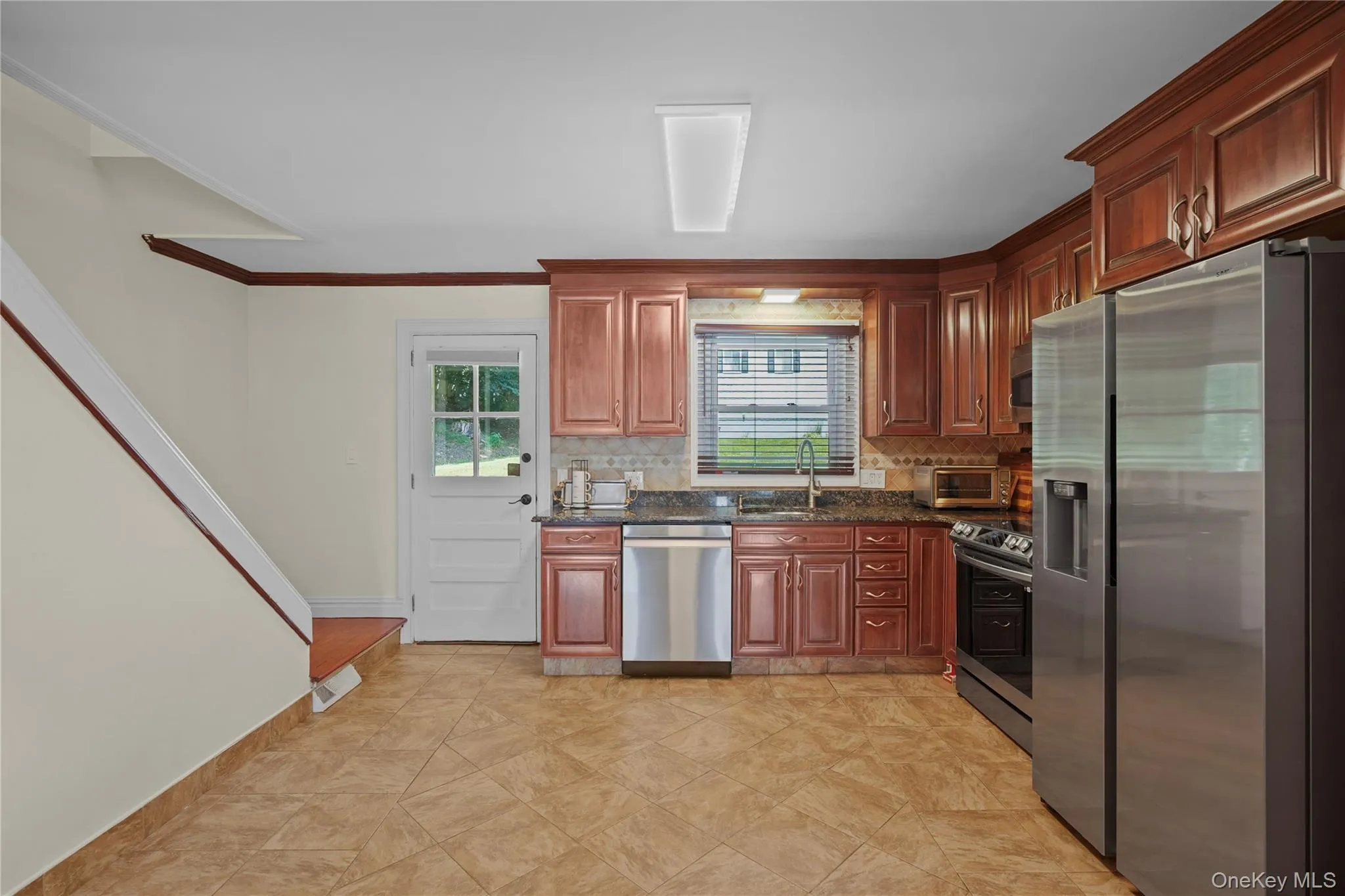 Bright kitchen with abundant natural light and access to the backyard Bright kitchen with abundant natural light and access to the backyard