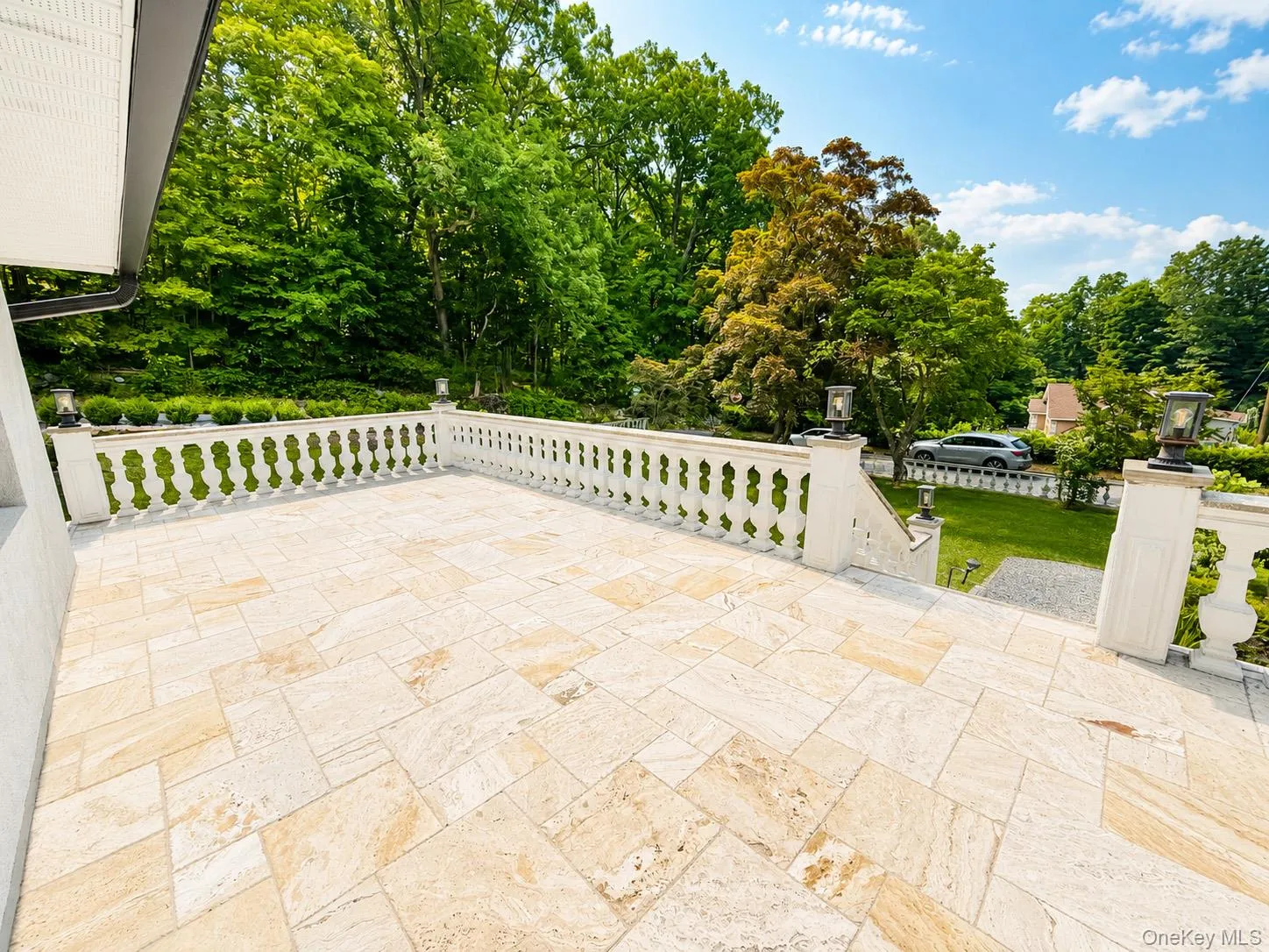 Welcoming view of the front terrace featuring an elegant balustrade Welcoming view of the front terrace featuring an elegant balustrade