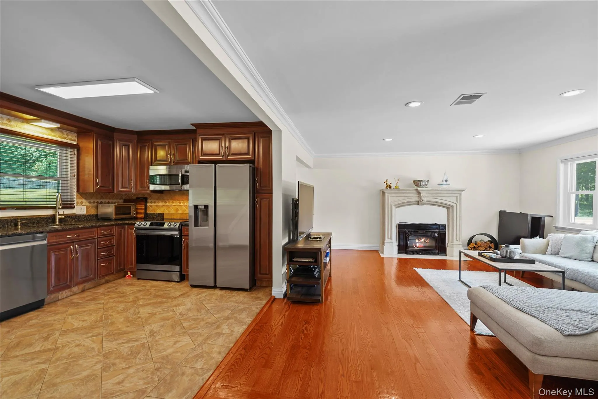 Another view of the kitchen open to living area with fireplace Another view of the kitchen open to living area with fireplace