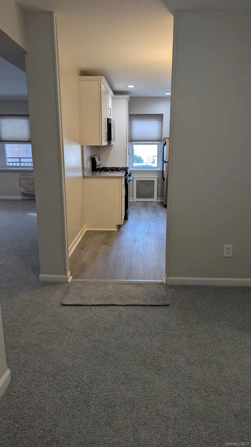 Kitchen with stainless steel appliances, plenty of natural light, and white cabinetry Kitchen with stainless steel appliances, plenty of natural light, and white cabinetry