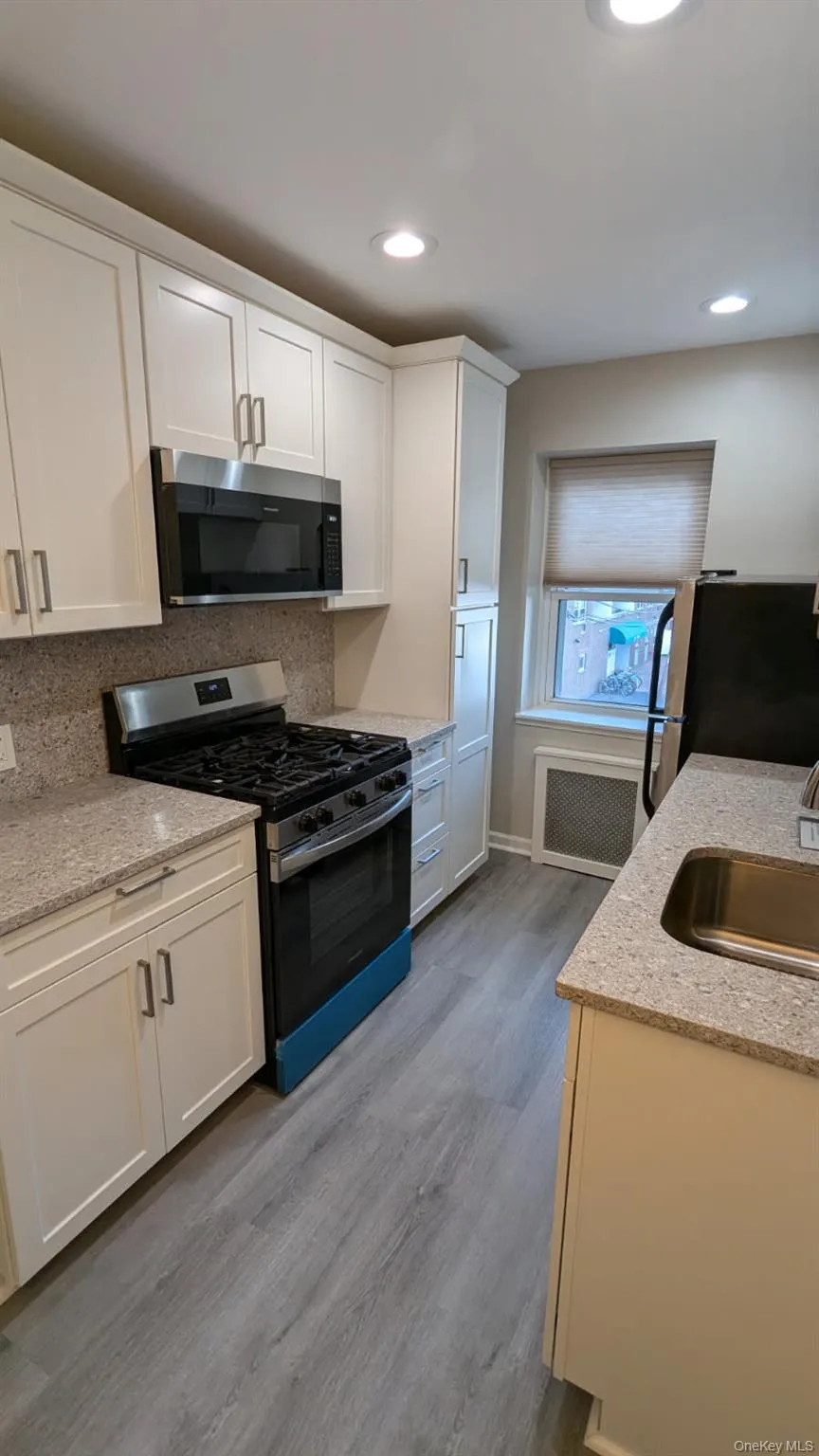 Kitchen with stainless steel appliances, a sink & white cabinets Kitchen with stainless steel appliances, a sink & white cabinets
