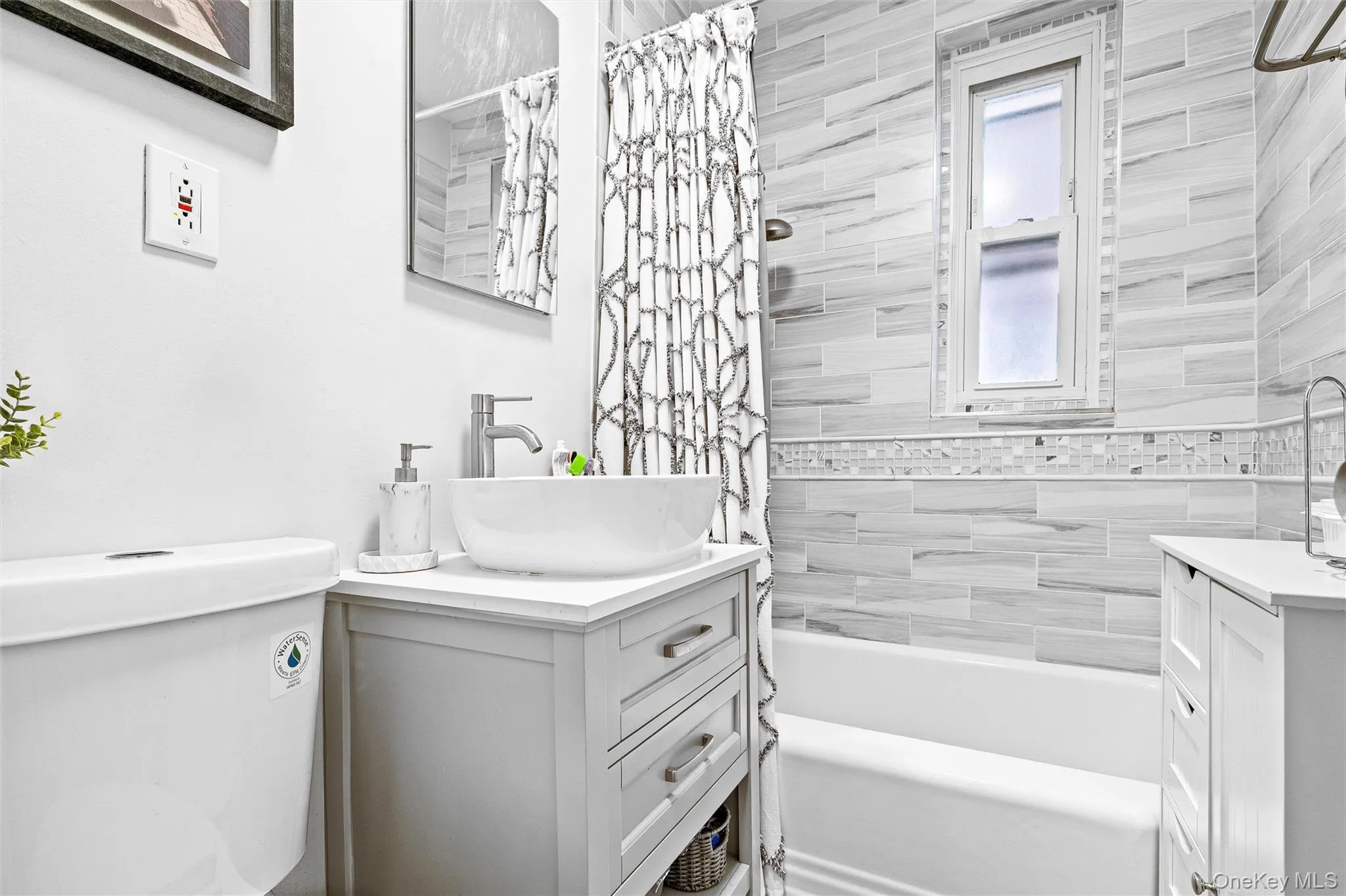 Bathroom featuring toilet, shower / tub combo with curtain, and vanity Bathroom featuring toilet, shower / tub combo with curtain, and vanity