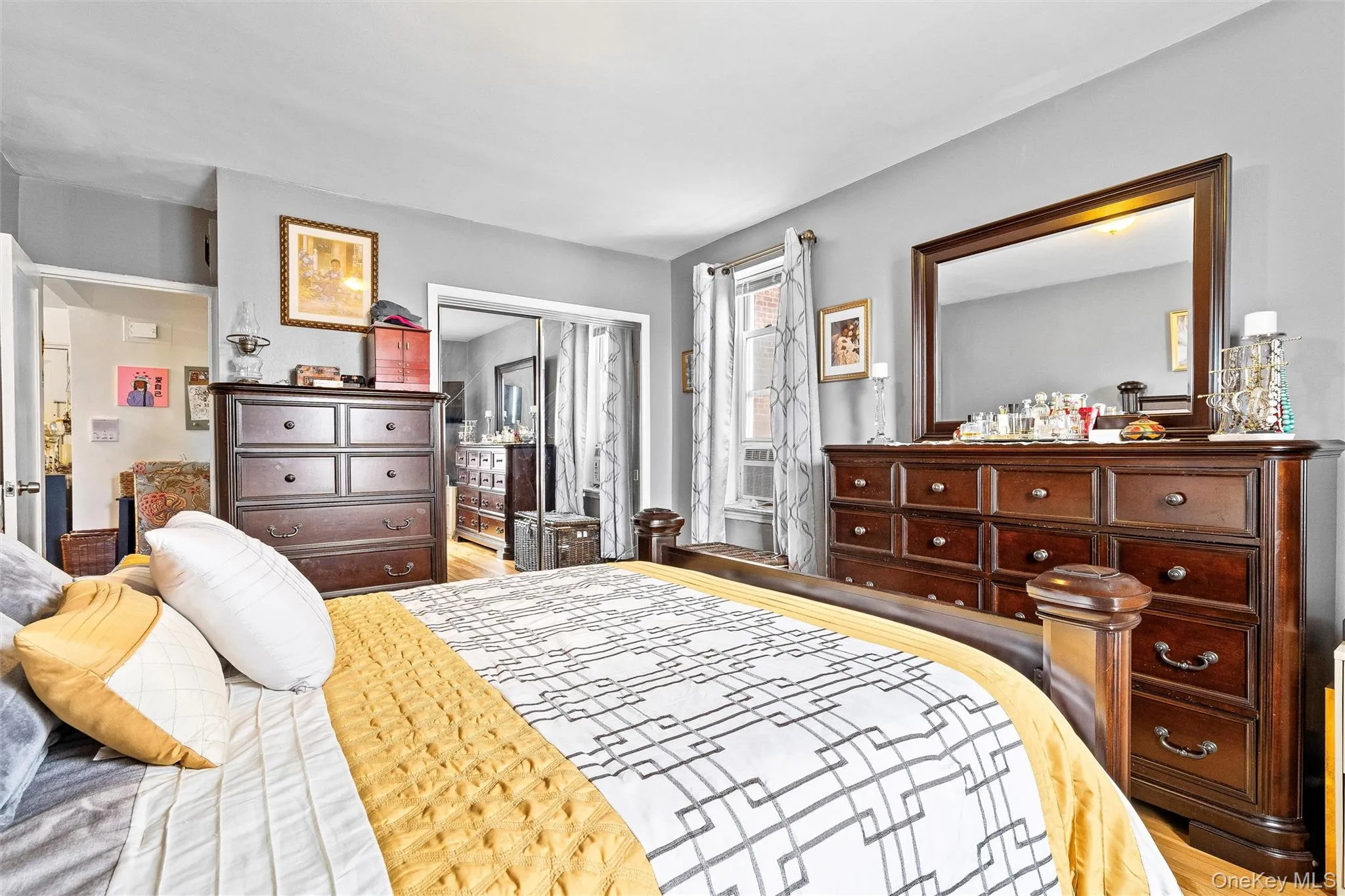 Bedroom featuring a closet and wood finished floors Bedroom featuring a closet and wood finished floors