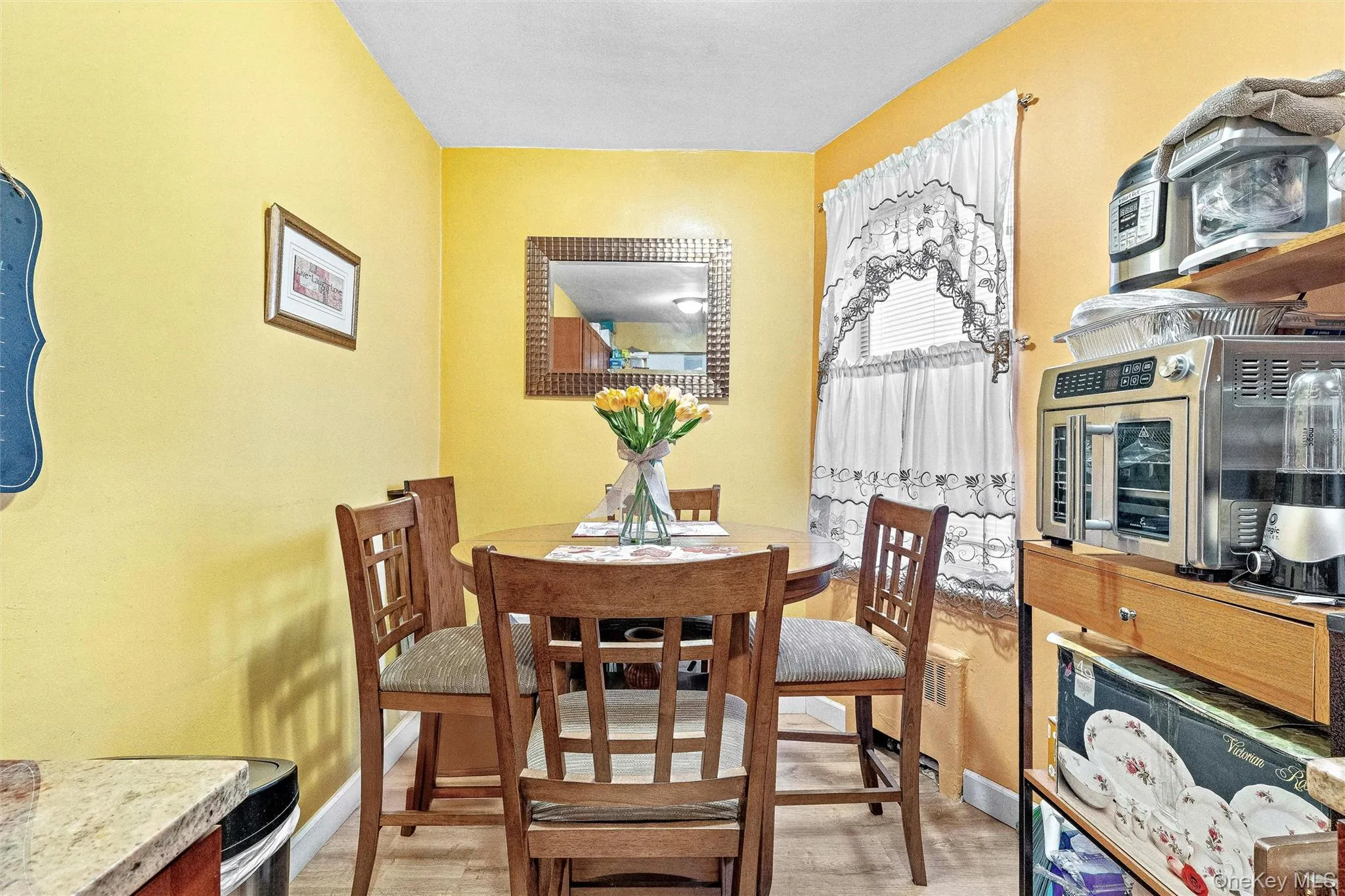 Dining space featuring a toaster and baseboards Dining space featuring a toaster and baseboards