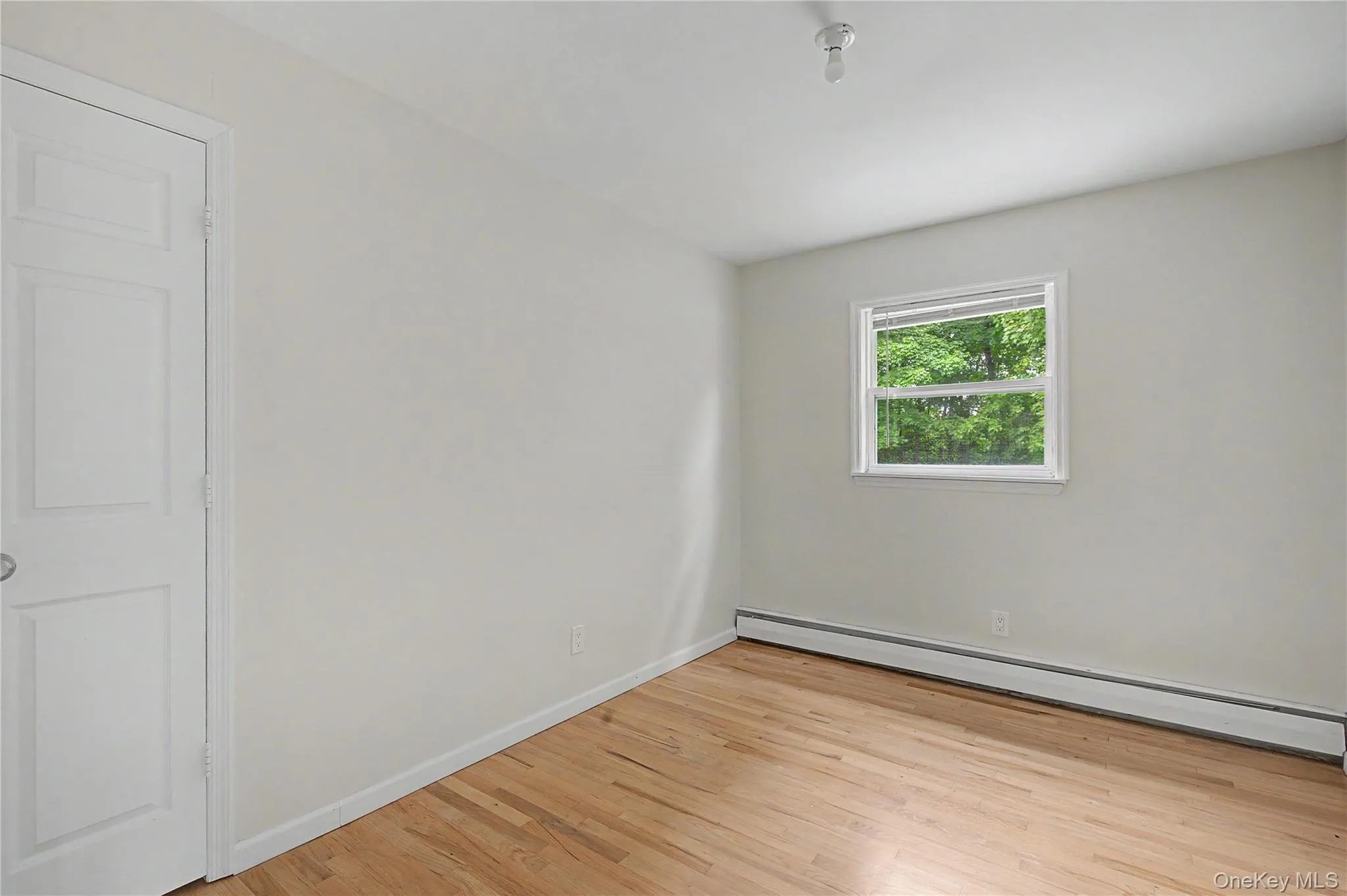 Comfortable bedroom with hardwood floors and large windows. Comfortable bedroom with hardwood floors and large windows.