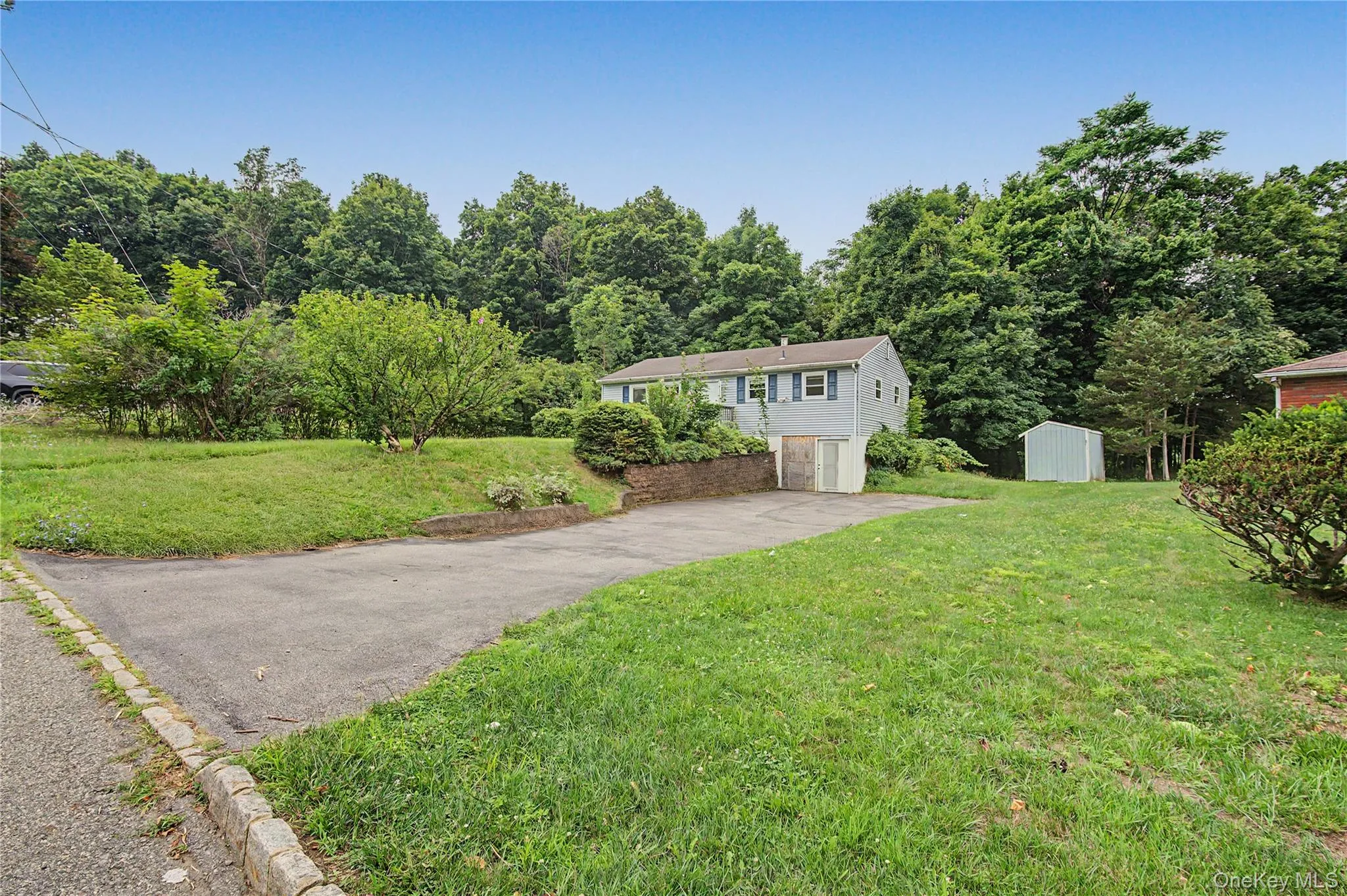 Expansive front lawn with ample parking and a quiet country setting. Expansive front lawn with ample parking and a quiet country setting.