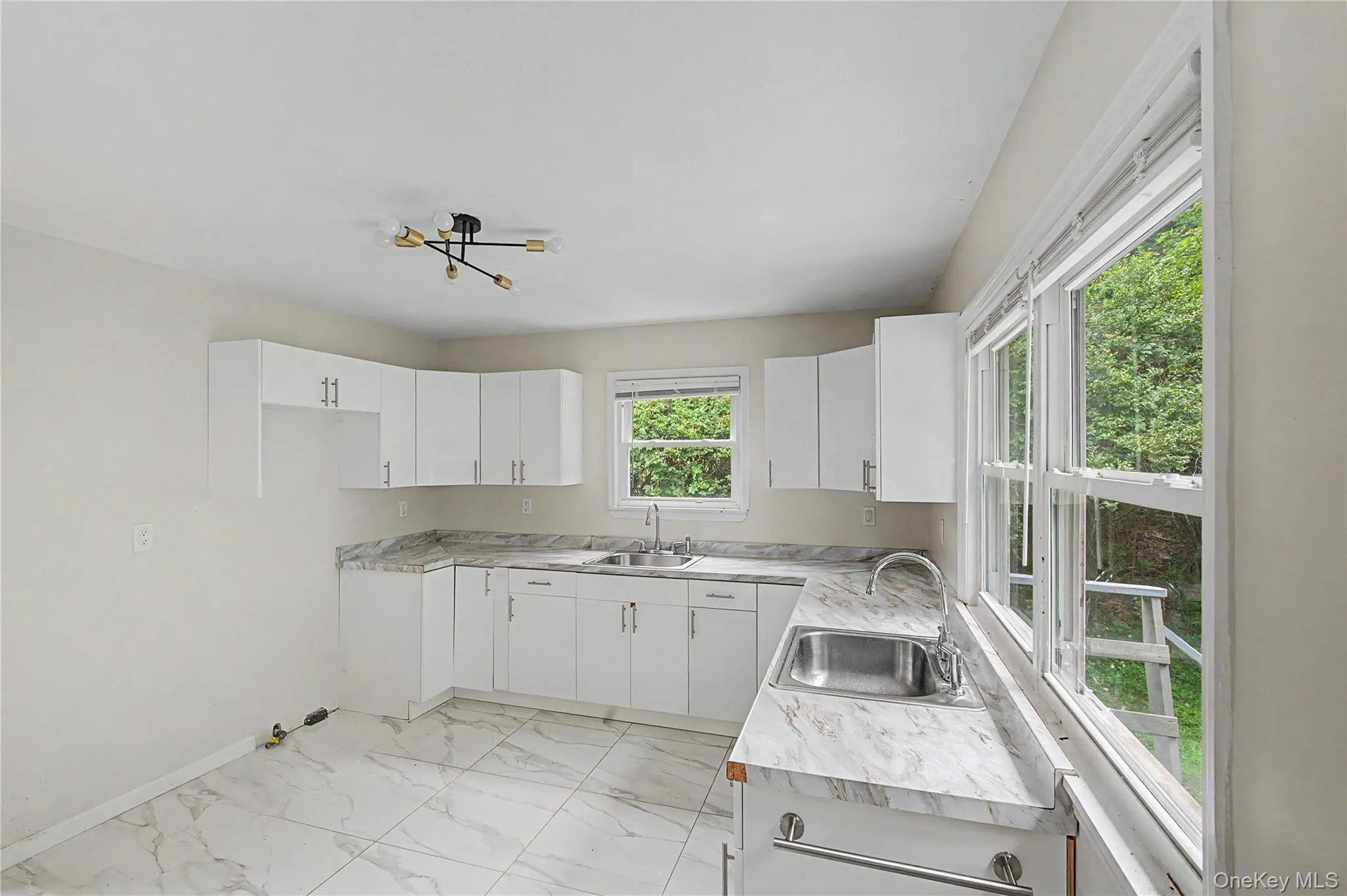 Enjoy serene backyard views and exceptional privacy from this bright, inviting kitchen. Enjoy serene backyard views and exceptional privacy from this bright, inviting kitchen.