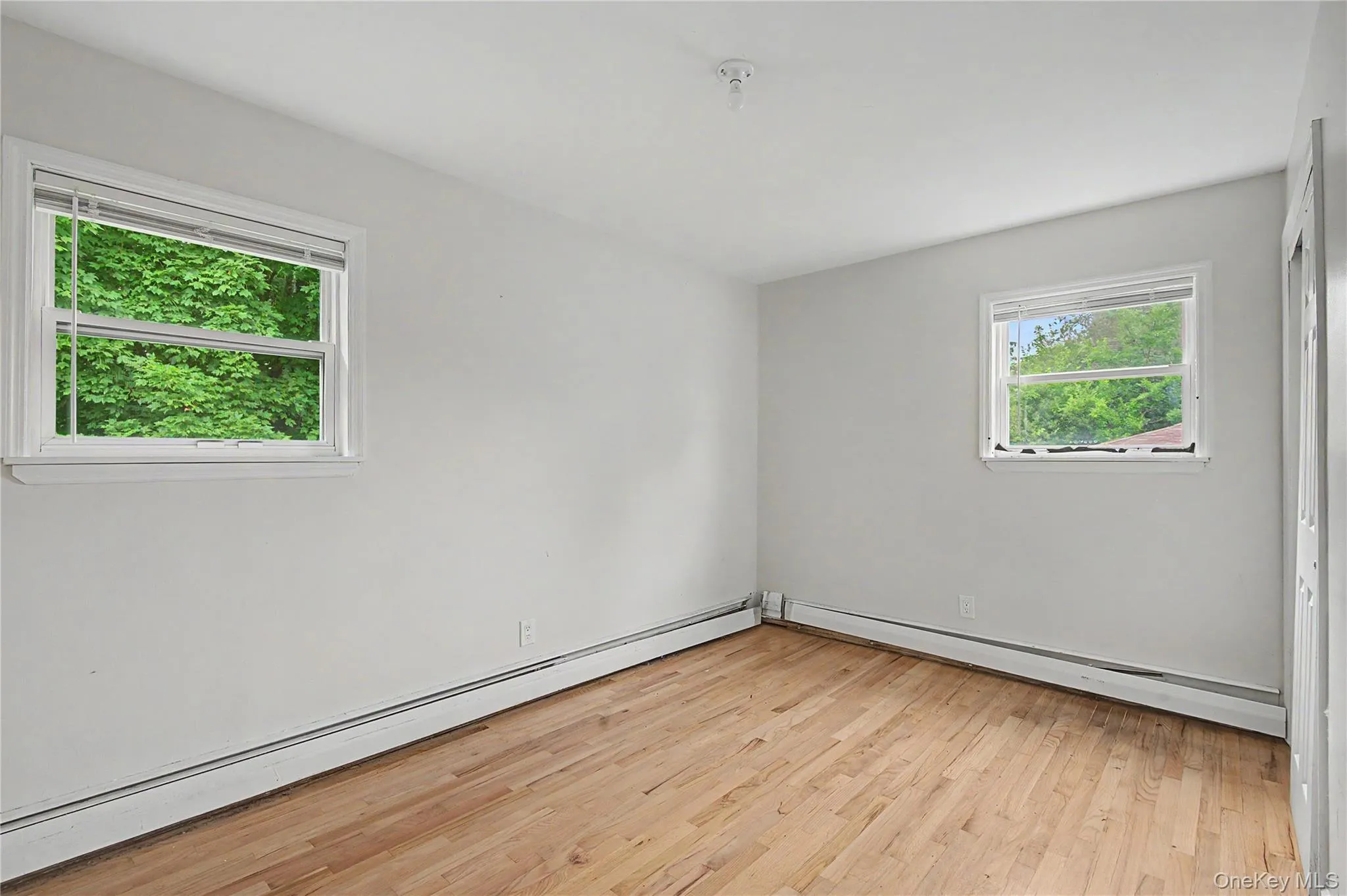 Bright bedroom offering peaceful views and plenty of natural light. Bright bedroom offering peaceful views and plenty of natural light.