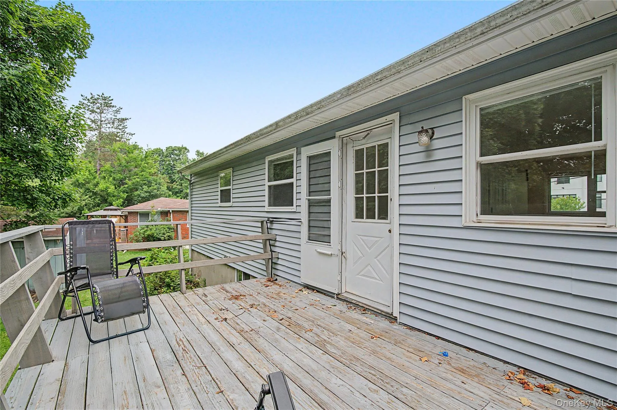 Spacious rear patio with outdoor seating and beautiful backyard views. Spacious rear patio with outdoor seating and beautiful backyard views.