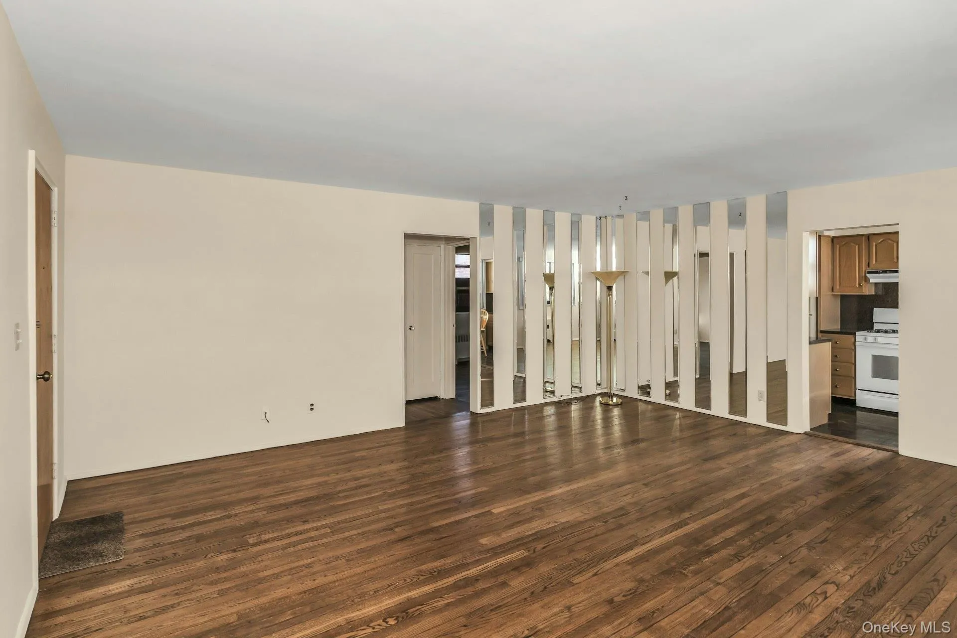 Unfurnished living room featuring dark wood finished floors Unfurnished living room featuring dark wood finished floors