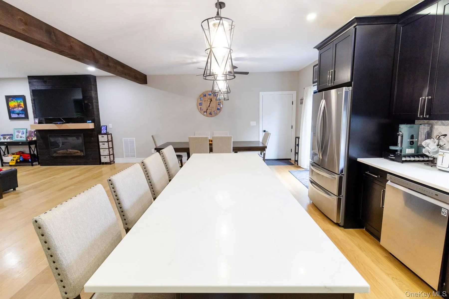 Elegant pendant lighting and generous island seating create an inviting focal point within the kitchen. Elegant pendant lighting and generous island seating create an inviting focal point within the kitchen.