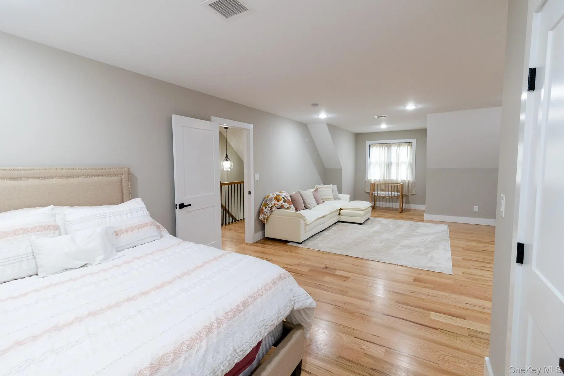 The generous room offers ample space for both restful evenings and a comfortable seating areas, creating a versatile sanctuary within the home. The generous room offers ample space for both restful evenings and a comfortable seating areas, creating a versatile sanctuary within the home.