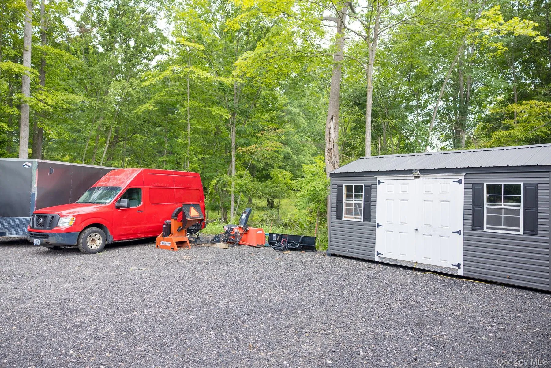 An expansive gravel parking area compliments the detached storage shed, providing practical space for parking, storage and everyday convenience. An expansive gravel parking area compliments the detached storage shed, providing practical space for parking, storage and everyday convenience.