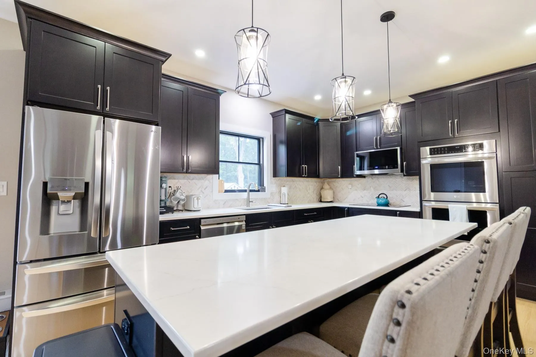 A spacious center island anchors the kitchen, offering the perfect place for meal preparation, casual dining and gathering with family and friends. A spacious center island anchors the kitchen, offering the perfect place for meal preparation, casual dining and gathering with family and friends.