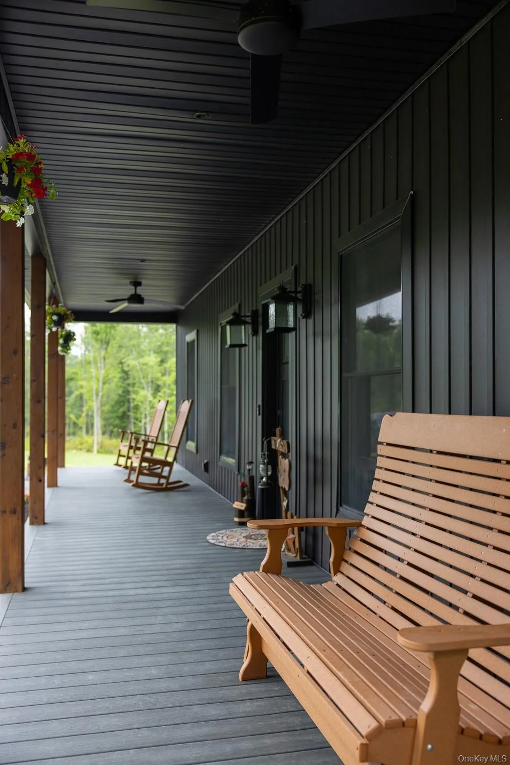 The deep covered porch extends the length of the home, creating a comfortable outdoor retreat with ceiling fans, room for ample seating and peaceful views in every direction. The deep covered porch extends the length of the home, creating a comfortable outdoor retreat with ceiling fans, room for ample seating and peaceful views in every direction.