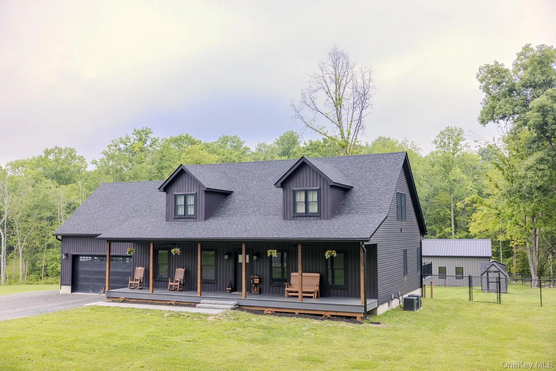 Bold architectural lines, classic dormers and a striking exterior create timeless curb appeal while blending natural beauty with the surrounding landscape. Bold architectural lines, classic dormers and a striking exterior create timeless curb appeal while blending natural beauty with the surrounding landscape.