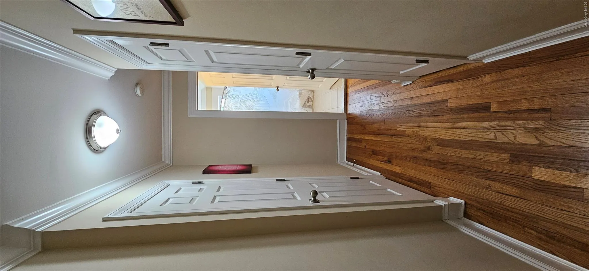 Hall featuring dark wood-style flooring and crown molding Hall featuring dark wood-style flooring and crown molding