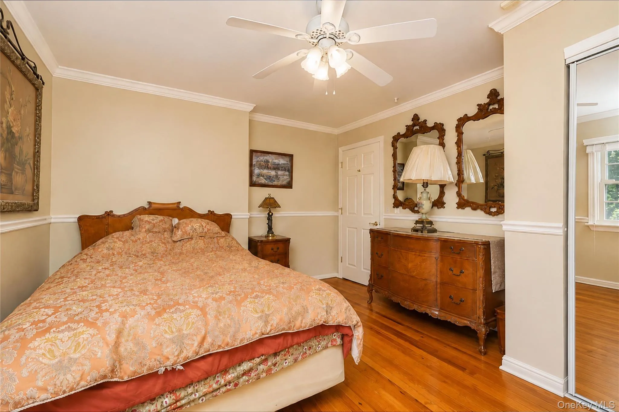 Hardwood flooring throughout featuring crown molding and chair rail detailing Hardwood flooring throughout featuring crown molding and chair rail detailing